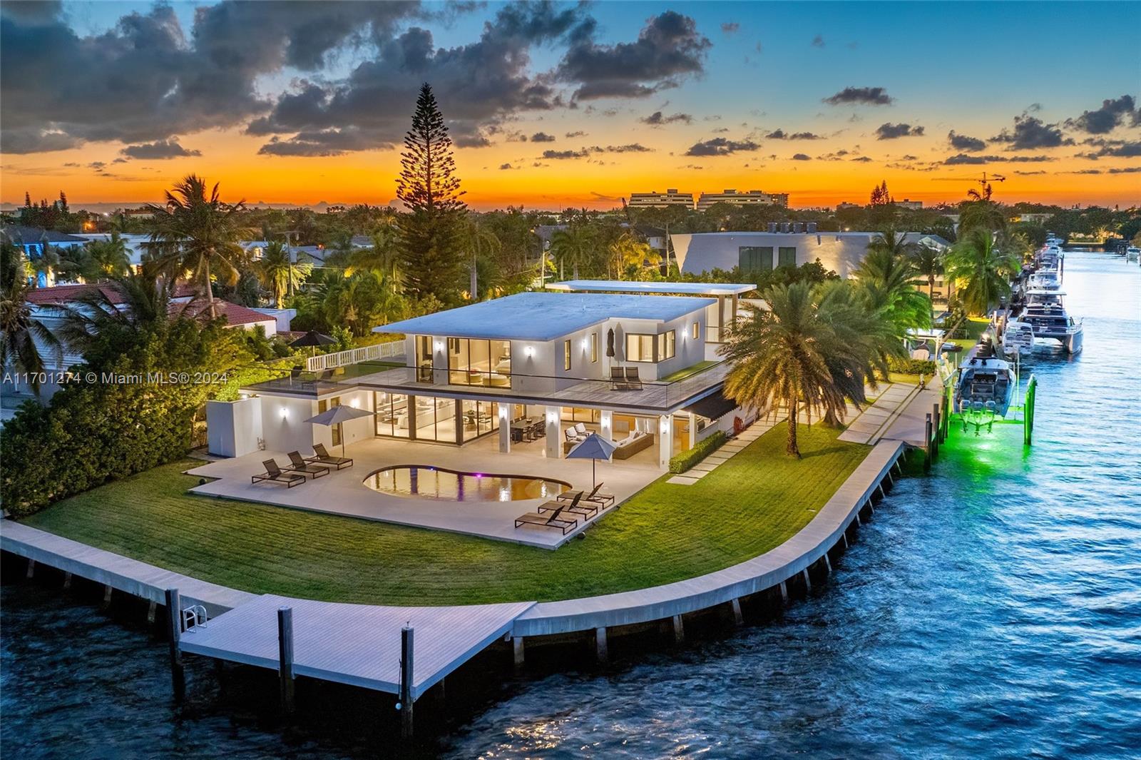 Experience unrivaled luxury in this meticulously renovated Point Lot estate, located on the open bay in the prestigious, gated San Souci Estates. The grand foyer and expansive great room offer soaring 20-ft ceilings bathed in natural light, creating an opulent first impression. This 5-suite residence boasts a chef's kitchen, oversized living and dining areas ideal for entertaining, and a versatile guest house. The upper level is dedicated to the primary suite, featuring a gallery hall, walk-in closet, and a private terrace with breathtaking bay views. Outdoors awaits a resort-style pool, Summer kitchen, and covered loggia. With 264 ft of Biscayne Bay frontage and panoramic views, this rare 18,253 SF estate is the perfect blend of elegance and sophistication. Schedule a private tour today!