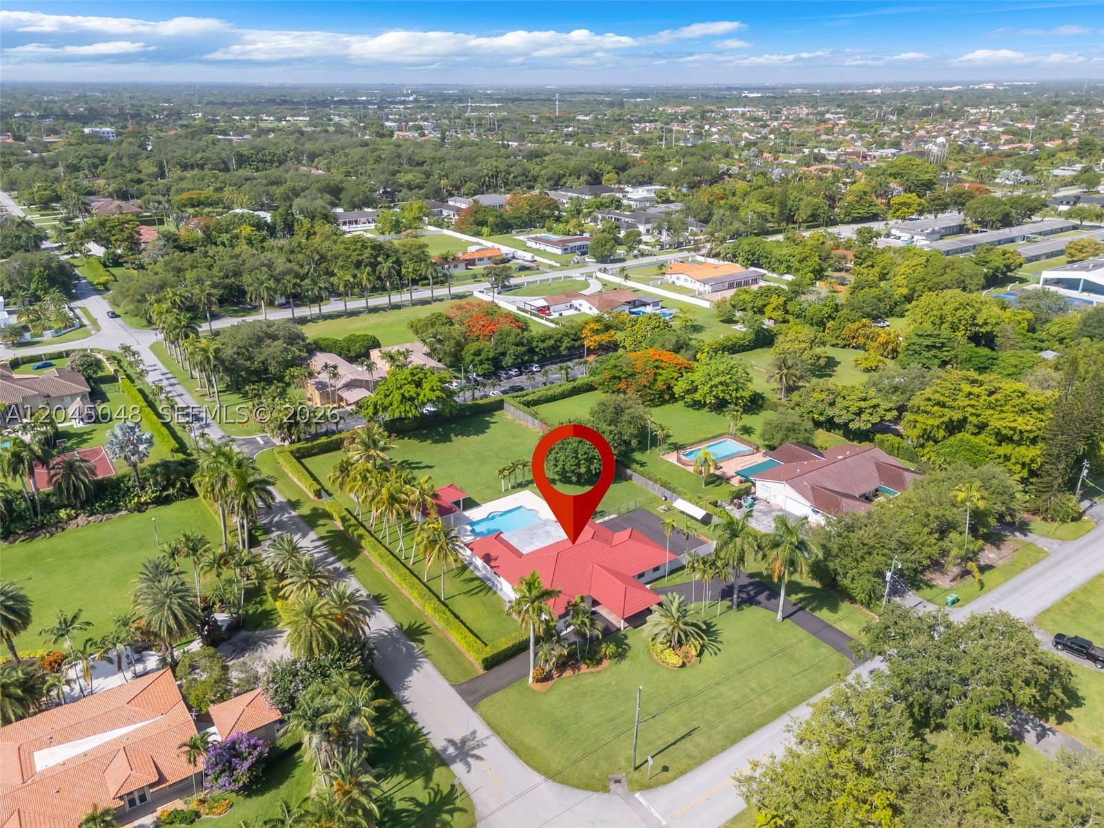 Rare 1+ acre estate lot in coveted Miller Drive Estates, a quiet enclave in the heart of Miami. This 4BR/3.5BA home was built in 1994 by a quality-focused developer, offering a solid foundation for its next chapter — move in or transform it into a custom luxury estate. The nearly acre-and-a-quarter lot offers endless potential: expand the home, add a guest house, build a pickleball court, or create a resort-style outdoor oasis.
Enjoy a sparkling pool, covered summer kitchen/cabana, and lush manicured grounds framed by mature palms. Inside features vaulted ceilings, an open kitchen with breakfast bar, spacious living areas, and a primary suite with corner soaking tub. Two car garage and long private driveway offer ample parking for cars, boats, or RVs.
Zoned for A-rated schools and not located in a Flood Zone for added peace of mind. Just 10 minutes to South Miami and 15 minutes to Coral Gables, with easy access to top dining and all of Miami. This neighborhood is transforming with new construction and high-end remodels — a rare opportunity to secure a large estate lot in an appreciating pocket of Miami before they're gone. The perfect place to call home.
