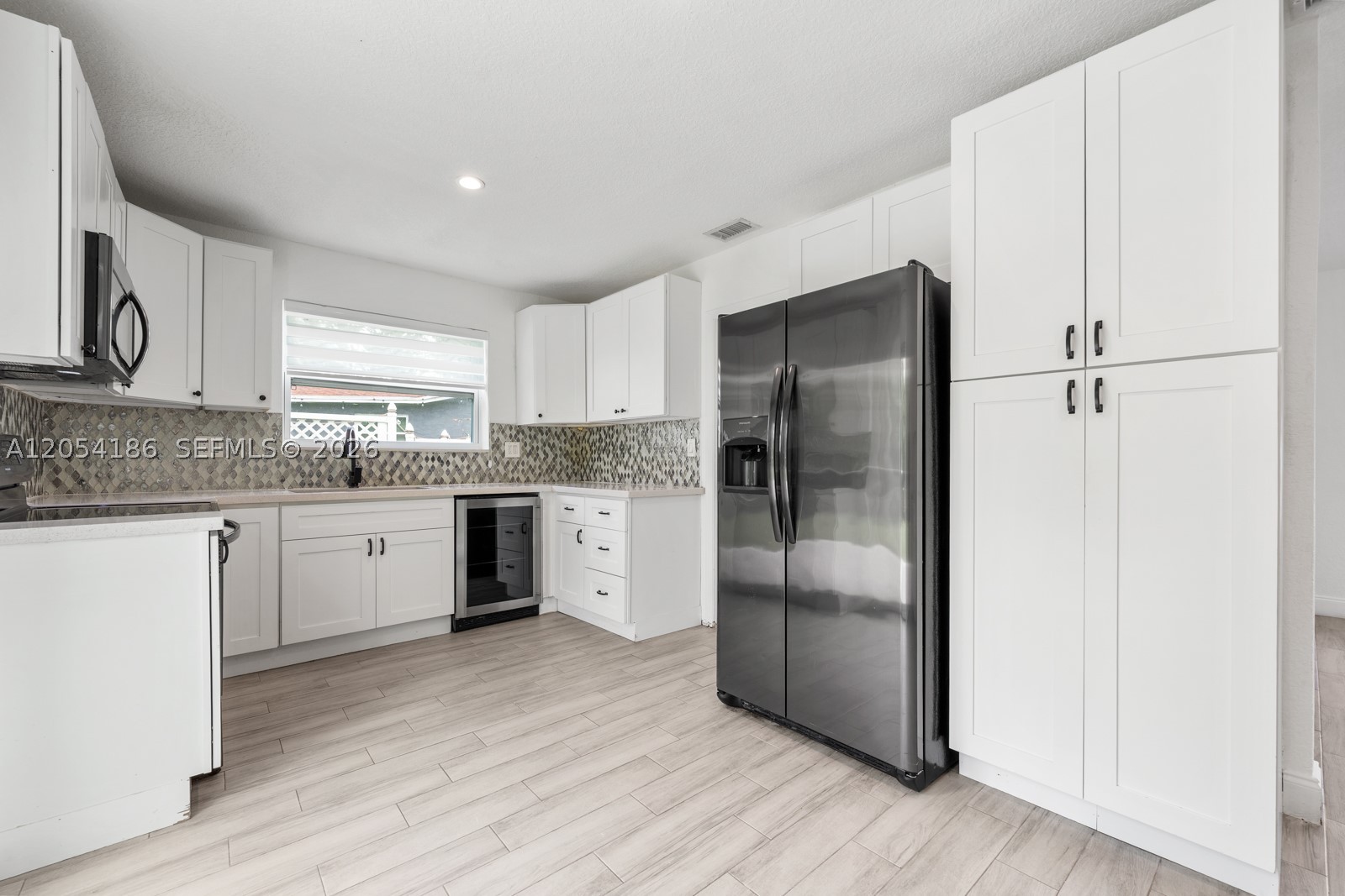 Welcome to this beautifully renovated 3-bedroom, 2-bath home featuring a desirable split-bedroom floor plan in a quiet Western Fort Lauderdale neighborhood. Conveniently located just minutes from I-95 and the Florida Turnpike, you'll enjoy quick access to shopping, dining, , the beach, parks, schools, and everything South Florida has to offer.

Step inside to a bright, open living area filled with natural light and overlooking the spacious, fully fenced backyard with peaceful river views. The covered patio is perfect for weekend barbecues, family gatherings, or simply relaxing while children and pets play safely outdoors.

The spacious kitchen offers plenty of cabinet and counter space, making meal preparation easy while staying connected with family and guests. A washer and dryer are conveniently located in the attached one-car garage, which also provides additional storage. The extended driveway offers extra parking for family and visitors.

The private primary suite is tucked away from the secondary bedrooms and features a walk-in closet, creating a comfortable retreat at the end of the day. The additional bedrooms provide flexibility for children, guests, or a home office.

Move-in ready with no HOA application and quick approvals available, this home offers the space, comfort, and convenience you are looking for.