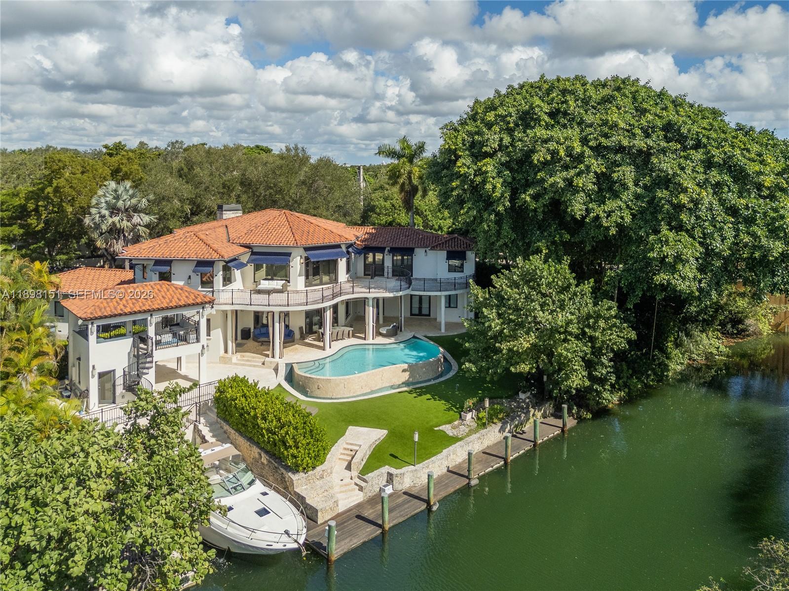 Discover an exceptional double corner lot estate on the peaceful Mahi Waterway in South Coral Gables. This boater’s paradise offers 197 feet of waterfront, a 60-foot dock and a rare grandfathered 40-foot boat slip with quick ocean access through just two high bridges. The residence features expansive living areas with tranquil water views finished in natural stone and Brazilian walnut, a gourmet kitchen with Wolf, Sub-Zero, True, and Miele appliances. Upstairs you will find two impressive master suites with a spacious loft. The spa inspired master bath includes a soaking tub and sauna. Highlights include dual gas fireplaces, a Fire Magic summer kitchen with bar and lounge, Crestron lighting, and a commercial grade audio system. Offered furnished or unfurnished, also available for lease.