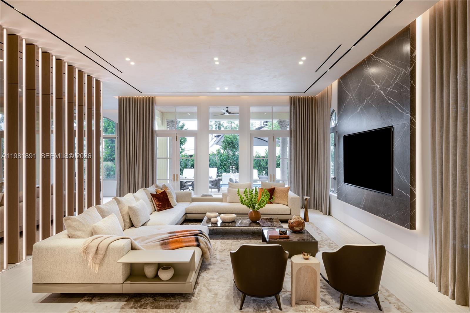 Located in the exclusive gated enclave of Villa Flora in Williams Island, this architectural masterpiece has undergone a meticulous transformation by Troy Dean Homes. With approx. 6,400sf of exquisitely finished interiors, the 6bd, 5ba/3.5ba residence has been thoughtfully redesigned, from bespoke custom millwork and handcrafted fabrications to seamless stone installations and integrated lighting. A multi-level sculptural staircase serves as the focal point upon entry. Warm white oak accents and hand-finished surfaces add depth and texture, creating a cohesive interior that feels both timeless and sophisticated. The chef’s kitchen with top-of-the line appliances and generously appointed living and dining areas on the 1st floor are accessible to the waterfront backyard offering a host of entertaining options. A heated pool/jacuzzi, outdoor kitchen/BBQ and built-in TV provide the ultimate outdoor refuge with marina access. Ascend to the 2nd floor via elevator or illuminated stairs to reach the informal study, two en-suite guest bedrooms and an idyllic Primary Suite complete with two grand walk-in closets, a spa-like bathroom, kitchenette and private patio overlooking the water. Top floor includes expansive family room, two bedrooms, an office/study, fitness room and state-of-the art movie theater. Crestron smart home technology, built-in floor to ceiling wine wall and an air conditioned two-car garage are just some of the key features that make this a one-of-a kind offering.