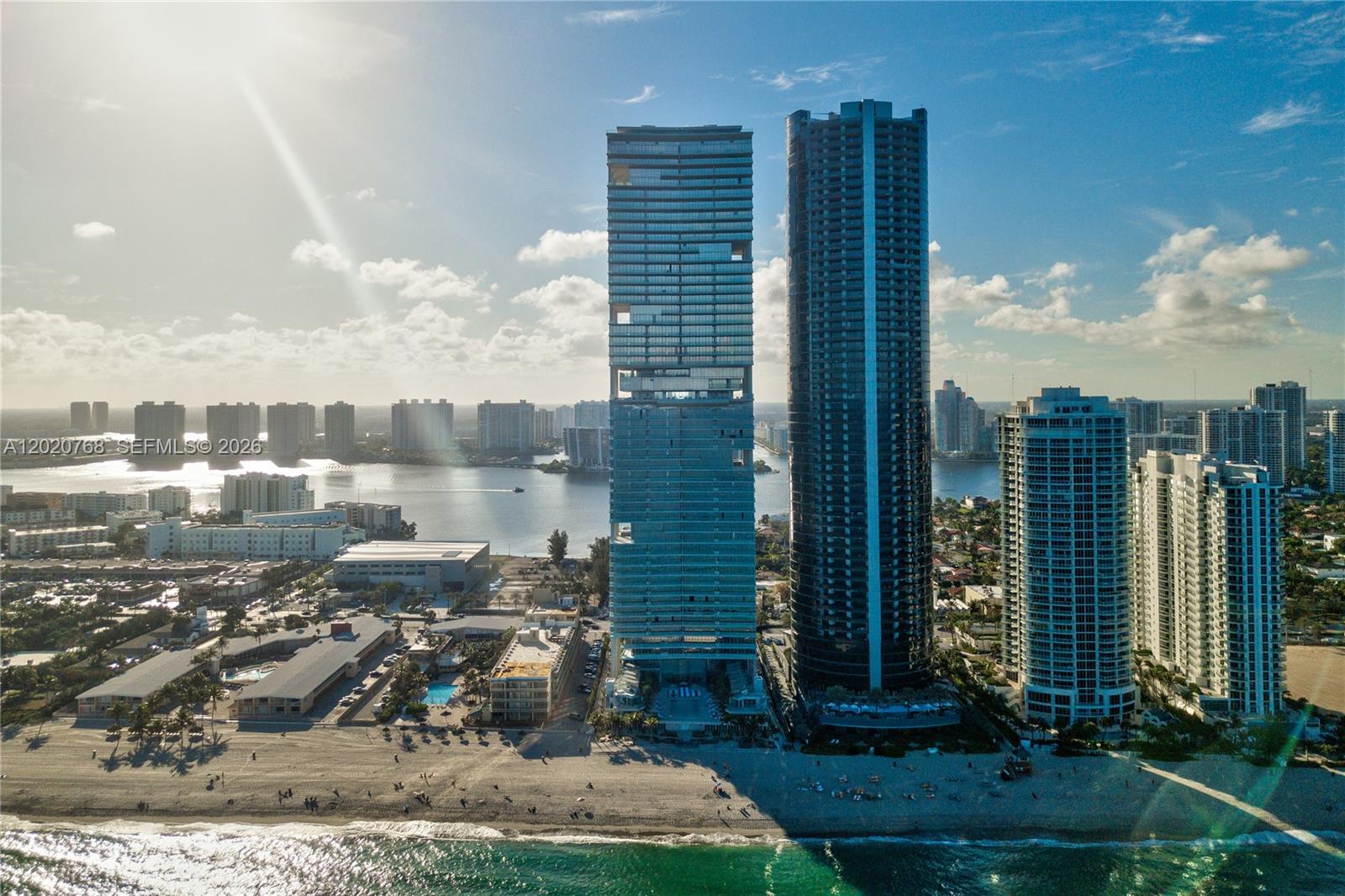 Experience luxurious oceanfront living at Turnberry Ocean Club Residences in Sunny Isles Beach. This spectacular flow-through residence offers breathtaking sunrise ocean views from the expansive east-facing terrace and stunning sunset bay and city skyline views from the west-facing terrace. Exceptionally designed with elegant Italian interiors and distinctive 12-foot ceilings, this residence features 3 spacious en-suite bedrooms plus a den with its own full bathroom and closet, ideal as a guest suite, office, or staff quarters. Porcelain floors, oversized terraces with summer kitchen, and a luxurious chef’s kitchen with custom Snaidero cabinetry, stone countertops, and top-of-the-line Gaggenau appliances complete the sophisticated living experience. The primary suite features expansive walk-in closets and a spa-inspired bath with steam shower. Residents enjoy over 70,000 SF of world-class amenities including the exclusive 3-story Sky Club, sunrise and sunset pools, wellness spa, private dining, entertainment areas, beach service, concierge, valet, security, guest suites, and more. Currently leased to an excellent tenant with prepaid rent through September 2027, making this an exceptional opportunity for investors or future end users planning ahead.