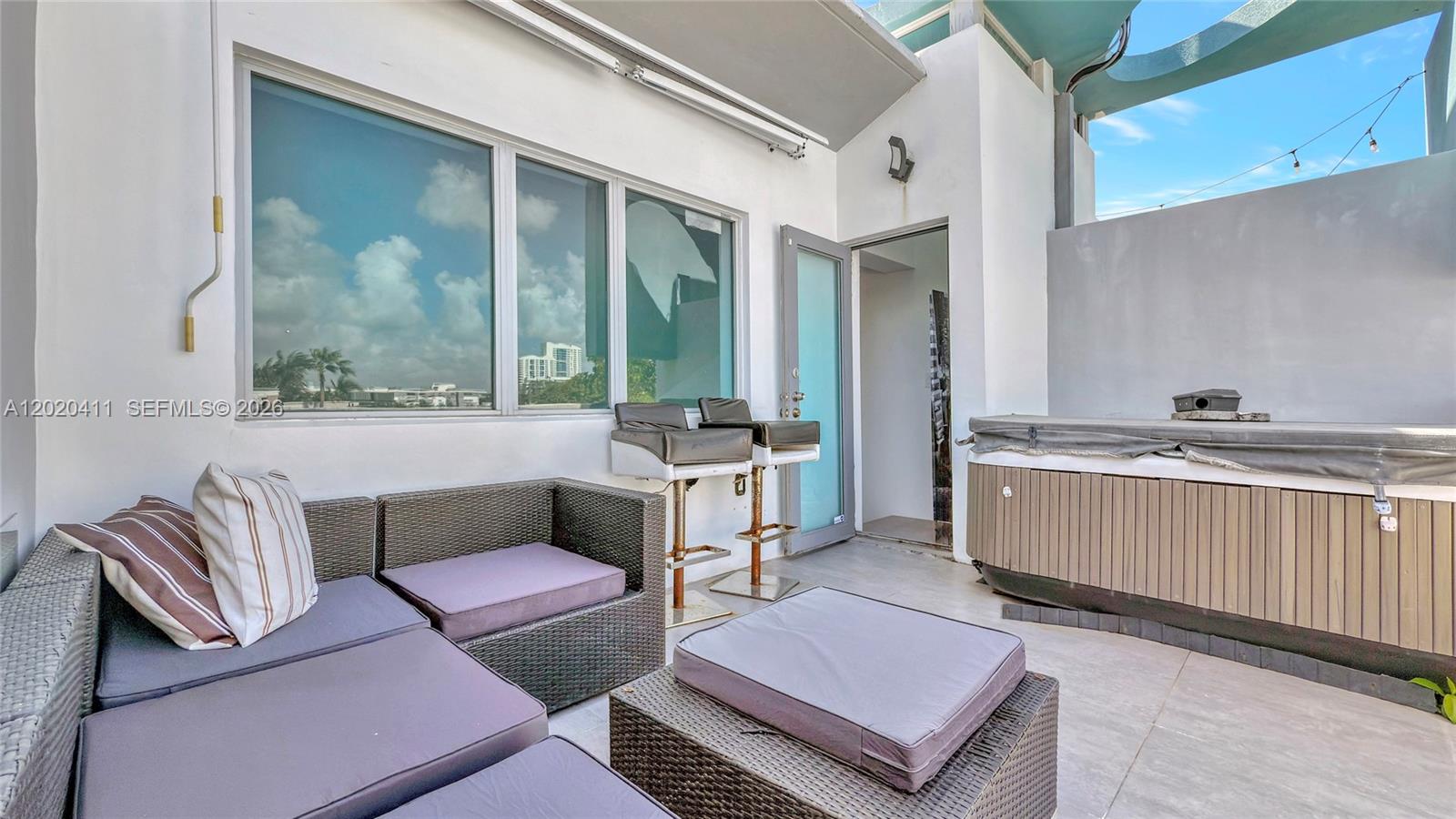 Remodeled trilevel Townhouse with 28 foot ceilings and new white porcelain plank flooring throughout. Very low Maintenance fees. Private rooftop terrace and hot tub. Quiet and secure building with only 7 units. Bright, open living space. Impact windows, 2 bedrooms?, and 2 full bathrooms. Includes 1 assigned covered parking space in a secure garage. Unbeatable location within 2 blocks of the shopping center at Alton Road and 5th Street. Walk to Flamingo Park, the beach, Lincoln Road, shops, and restaurants. Publix, Total Wine, and Whole Foods are just around the corner. This exclusive, private residence offers luxury in a prime location without the hassle of high-rise living, with very low maintenance fees.