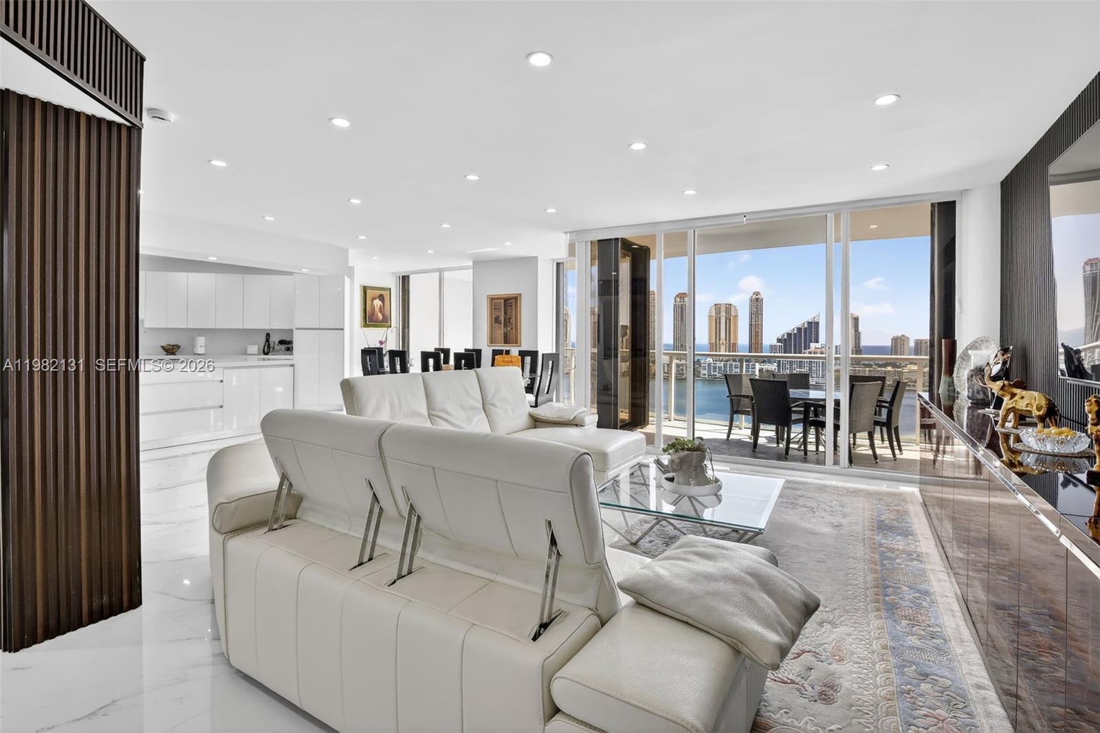 Wow! Spectacular Ocean Views From This Completely Renovated Two Story 3 Bed + Staff Quarters/ 4.5 Bathroom Modern Home In The Sky with Elevator. No Expense Was Spared & Nothing Original Remains! Stunning White Light/ Bright Residence Has The Finest Finishes incl. Open White State of the Art Kitchen with Top Of The Line Appliances, White Quartz Countertops, White Gloss Cabinets, All Large Italian Porcelain Floors Throughout, Custom Lighting, Smart Home, New Bathrooms, Enlarged Shower In Primary Bathroom with Seperate Sauna, Electric Shades, Huge Terraces w/ Floor To Ceiling Glass To See The Ocean, Intracoastal, City Views. This 84 Acre Island Paradise Offers Country Club Amenities Featuring State Of The Art Spa Bldg w/ workout Classes, Indoor Swimming Pool, 15 Tennis Courts, Pickle Ball Club, Kids Tennis Camp/ Lessons, 3 Restaurants, Starbucks, Deli, Kid's Playground, Marina, Courtesy Bus, Exercise Path, & More!