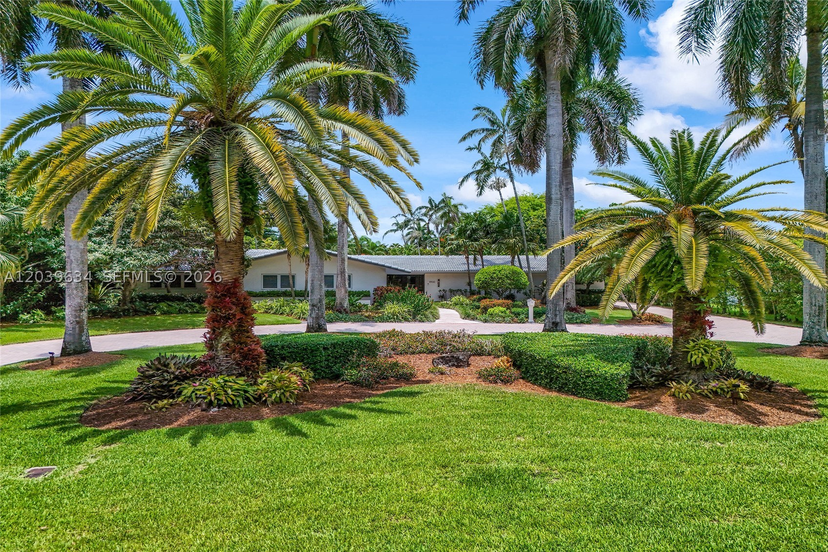 Nestled on a lush builder’s acre along a quiet winding street in the heart of Pinecrest, this one of a kind custom estate offers 6,287 SF of thoughtfully designed living space, all on one level. Featuring 5 bedrooms, 2 offices/flexible use rooms, and 5.5 bathrooms, this residence is filled with natural light and blends elegance, comfort, and functionality.The open-concept chef’s kitchen showcases custom wood cabinetry, a tropical inspired glass mosaic backsplash, professional grade appliances, and a coffee bar with refrigerated cooling drawers. Expansive living and family areas, including a dramatic entertaining room with soaring ceilings, flow seamlessly for both everyday living and large-scale entertaining. Rich architectural details and tumbled marble flooring enhance the home’s timeless appeal.The luxurious primary suite serves as a private retreat with custom walk-in closets and a spa-inspired bath designed for relaxation.Step outside to your own private resort featuring an oversized pool, outdoor spa, expansive covered terrace, and beautifully landscaped grounds, creating a true vacation-at-home experience and effortless indoor/outdoor living.Additional highlights include an oversized 3 car garage, new main roof, and impact-resistant windows and doors throughout most of the home. Ideally located near top rated schools, private academies, premier shopping, dining, and major commuter routes, this home offers the perfect balance of privacy, luxury, and convenience.