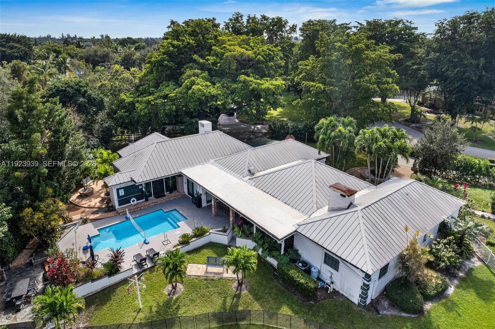 Magnificent 8-bedroom, 4-bath LAKEFRONT POOL HOME on a builder’s acre in the heart of Davie! This stunning family estate has been beautifully renovated and features a unique wood-cabin–style section that creates the perfect vacation-home feel. The property boasts an aluminum roof, gorgeous landscaping, and an inviting outdoor kitchen—ideal for entertaining. Enjoy an impressive lineup of outdoor amenities including a ½-court basketball court, mini golf area, kids’ playground, and a charming gazebo, all overlooking serene lake views. Spacious layout, incredible outdoor living, and a quiet, desirable community make this home truly one-of-a-kind. A must-see property!