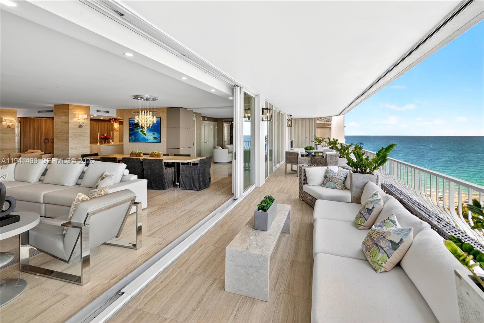 Exceptional full-floor residence offering 3,340 SF of interior space and a 70-ft long south-facing balcony with panoramic views of the Atlantic Ocean, Miami skyline, and Biscayne Bay. The apartment was completely gutted and rebuilt, including new electrical, plumbing, HVAC, floors, walls, ceilings, and impact hurricane doors and windows with oversized openings. The residence features marble floors and walls throughout the main living areas and primary suite, custom lighting designed for multiple moods, and electronic blackout shades and draperies. The custom kitchen by Poggenpohl and Downsview includes a 10-ft Dolce Quartzite island, Sub-Zero refrigeration, Gaggenau cooktop, Wolf oven, two dishwashers, pantry storage, and extensive custom cabinetry. The spacious primary suite offers balcony access, custom closets, and a luxurious marble bath with double vanity, double shower, private bidet/toilet room, and seating area. The second bedroom is an oversized en-suite, while the third bedroom features a custom Murphy bed and flexible layout for open or enclosed use. The expansive balcony is finished with porcelain tile, and equipped with shutters for weather protection, ideal for indoor-outdoor living. Sale includes private cabana. Ideally located moments from Miami’s finest beaches, dining, and shopping, with seamless access to major routes.