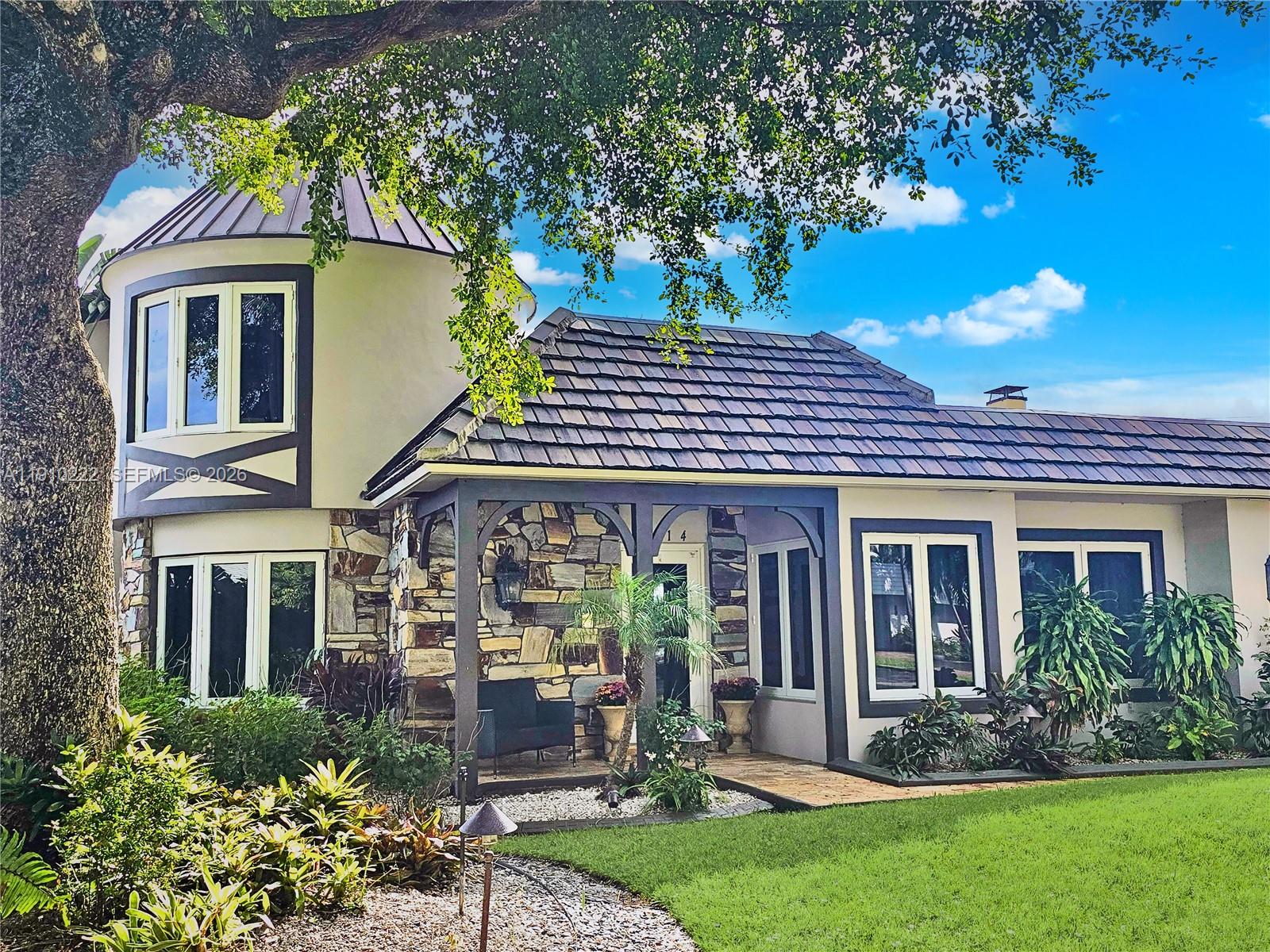 If your dream has been to own in Palm Beach, but the price tag feels out of reach, then look no further. Experience the classic Palm Beach lifestyle, but with the Hillsboro Shores advantage. Quietly nestled in Broward County, you can have it all.  Just steps from the beach, your HSIA membership provides deeded beach access, while the neighborhood offers the ambience of a friendly, private seaside community.  This lovely 4/3 residence has been thoughtfully updated and maintained, blending architectural charm, modern convenience, and  coastal living. The home’s signature, European copper turret anchors the design, with an elegant, curved dining room and a light-filled bedroom above. Albastrino travertine floors, a limestone feature wall with working fireplace, and a sculptural floating staircase add warmth and character. The chef’s kitchen offers high-gloss cabinetry, Bosch and Dacor appliances, and crystal marble countertops. The first-floor primary suite includes custom cabinetry, walk-in closet, and spa bath with champagne-bronze fixtures, soaking tub, and shower. Custom touches include built-in office cabinetry and a guest-room Murphy Bed wall system with lifetime warranties. The fenced backyard features a summer kitchen, saltwater pool with waterfall, tumbled-marble pavers, and lush landscaping. Freshly painted, warrantied tile roof, newer A/C, impact windows/doors, natural gas, and an inspection complete this turn-key home. Property page and brochure available.