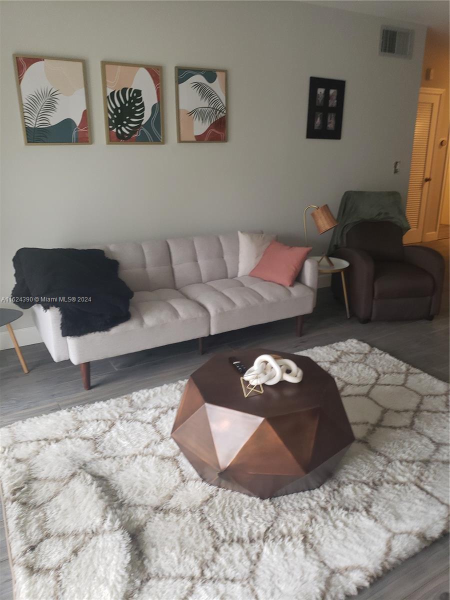 COME AND SEE THIS BEAUTIFUL second floor 1 bedroom, 1 and 1/2 bathrooms condo with New Floors & Screened Patio located in Building #10.  Community has heated pool, sauna, rental cabanas, security patrol & BBQ area and is located within walking distance to shops, restaurants, parks & hospital. It is also very close to beach!