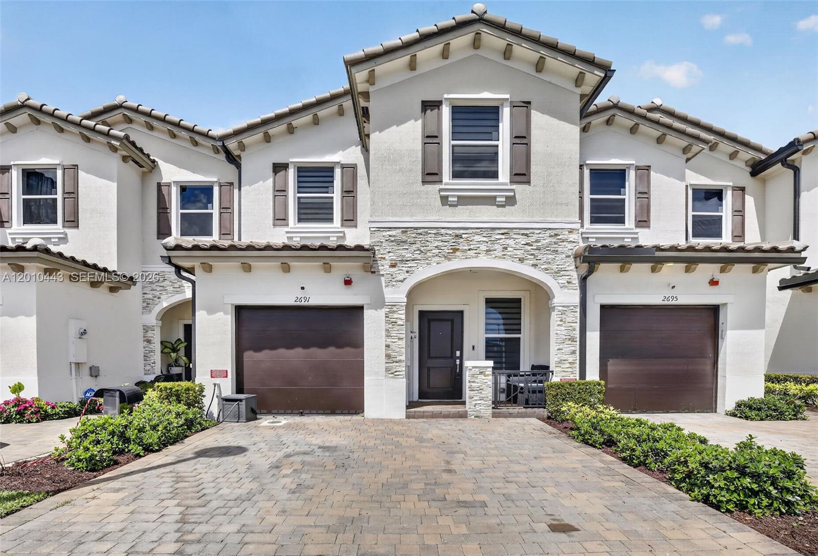 Your wait is over—newer 2023 construction! This fee-simple Crimson Model townhome in sought-after Azalea Isle at Lauderhill offers 3 bedrooms, 2.5 baths, and a 1-car garage with an inviting floor plan. The open kitchen features white European-style cabinetry, quartz countertops, a large single-bowl undermount sink, and stainless-steel appliances. Upstairs, the spacious primary suite includes a tray ceiling, oversized walk-in closet, and spa-style bath with dual-sink vanity and glass-enclosed shower. Enjoy generous secondary bedrooms, full-size washer/dryer, ceiling fans, modern LED lighting, designer zebra blinds, and an energy-efficient tankless water heater. Step outside to a private enclosed yard with artificial turf and pavers perfect for low-maintenance living and entertaining. Residents enjoy a community playground, 24-hour gated security, and a pet-friendly community. Low HOA includes cable TV, internet, and landscaping. Centrally located near shopping, dining, entertainment, beaches, schools, and major travel routes.