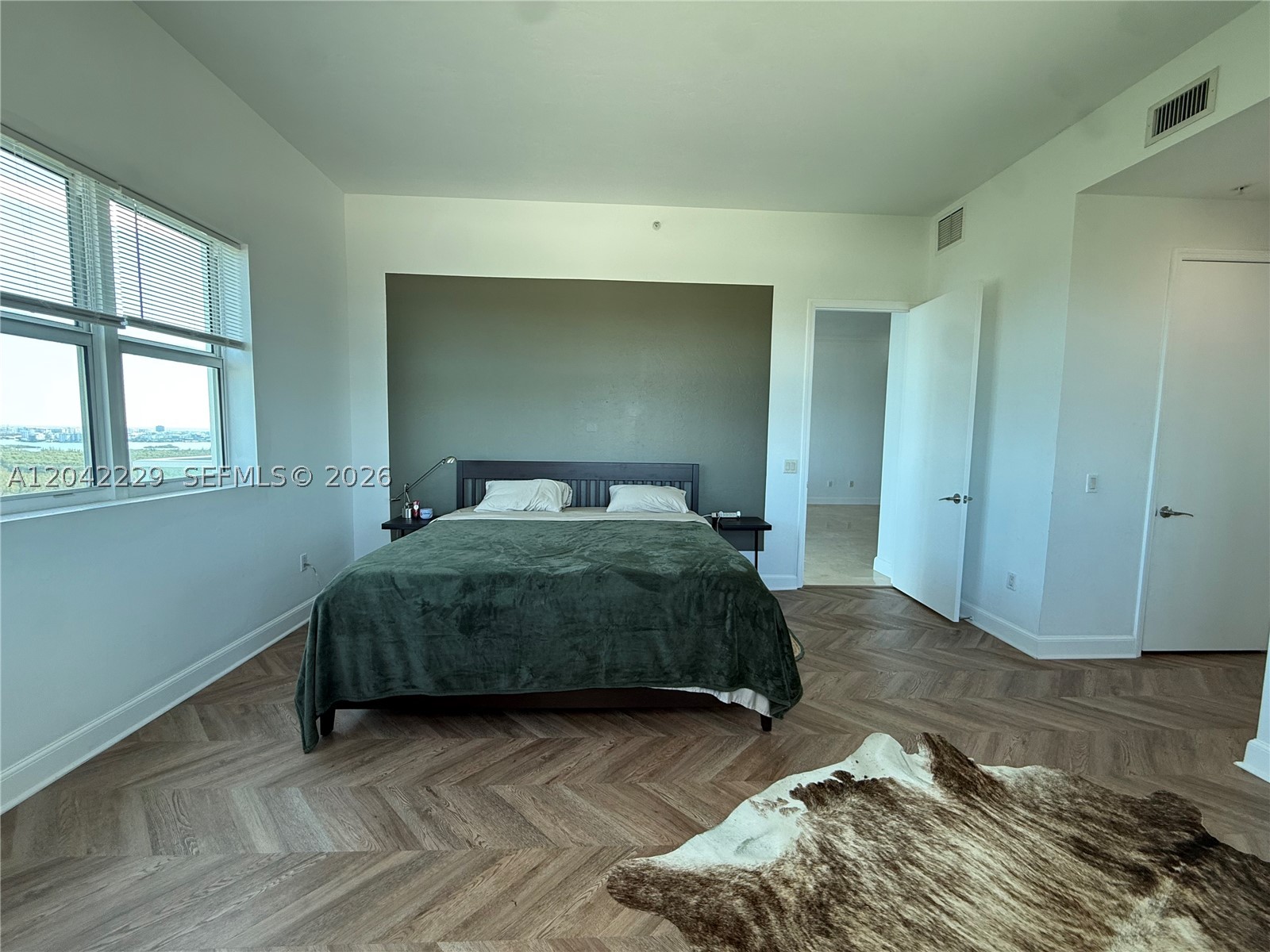 Rarely available penthouse corner residence offered for sale by its original owners! This spacious 2-bedroom, 2-bath plus den features soaring 12-ft ceilings and expansive skyline views of Sunny Isles Beach, Haulover, and Bay Harbor Islands. The layout feels grand and filled with natural light. Stone floors have just been polished, and both bedrooms feature brand-new Chevron-style engineered herringbone wood flooring. Dishwasher, microwave, and stovetop are brand new. This is the only line in the building with no windows facing the catwalk, offering enhanced privacy and additional windows, including a windowed foyer, all bathrooms, and extra windows in the primary bedroom. Thick hurricane-impact windows provide excellent sound insulation. Assigned covered parking conveniently located on the first level, with the option to rent a second space. A must-see penthouse. Building amenities include pool, gym, tennis court, playground, dog wash station, and high-speed internet/cable. Conveniently located near Costco, Target, Publix, new Mater Academy, UM Health, Pura Vida, Reserve Padel, and the beaches.