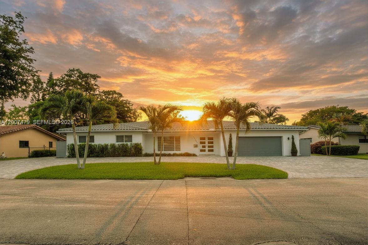 Exceptional remodeled single-family home located in the heart of the Country Club of Miami. This property features 4 bedrooms and 4 full bathrooms, with stylish 32x32 porcelain tile throughout. The home is fully equipped with impact windows, Bahamas blinds, and zebra shades for both security and style.

The oversized master bedroom is a particular highlight, featuring an exquisite attached sitting area that offers the versatility to be used as a nursery, home office, exercise room, or an expansive custom walk-in closet, making it a woman's dream closet space!. It also features another walk-in closet and remodeled bathroom with double sink, jacuzzi tub and standing shower. 

For those who enjoy entertaining, the kitchen includes modern cabinets with hydraulic dampers for soft close and a decorative backsplash. The spacious living room is filled with natural light and overlooks a screened pool and patio area, providing a serene view of the golf course. The patio includes a full kitchen with refrigerator, gas stove and barbeque, along with sink and separate terrazzo space for large patio furniture. The pool area connects to a full bathroom for easy access and convenience, This convenient set-up allows guests to use the restroom to change or shower without having to enter the main house. Six camera surveillance system around the property. 

The house has two AC units. Club membership required. Association approval required. Call listing agent for more information