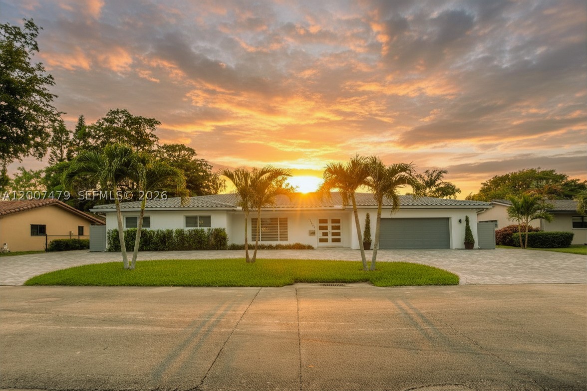 **Price Reduction** Exceptional remodeled single-family home located in the heart of the Country Club of Miami. This property features 4 bedrooms and 4 full bathrooms, with stylish 32x32 porcelain tile throughout. The home is fully equipped with impact windows, Bahamas blinds, and zebra shades for both security and style.

The oversized master bedroom is a particular highlight, featuring an exquisite attached sitting area that offers the versatility to be used as a nursery, home office, exercise room, or an expansive custom walk-in closet, making it a woman's dream closet space!. It also features another walk-in closet and remodeled bathroom with double sink, jacuzzi tub and standing shower. 

For those who enjoy entertaining, the kitchen includes modern cabinets with hydraulic dampers for soft close and a decorative backsplash. The spacious living room is filled with natural light and overlooks a screened pool and patio area, providing a serene view of the golf course. The patio includes a full kitchen with refrigerator, gas stove and barbeque, along with sink and separate terrazzo space for large patio furniture. The pool area connects to a full bathroom for easy access and convenience, This convenient set-up allows guests to use the restroom to change or shower without having to enter the main house. Six camera surveillance system around the property. 

The house has two AC units. Club membership required. Association approval required. Call listing agent for more information