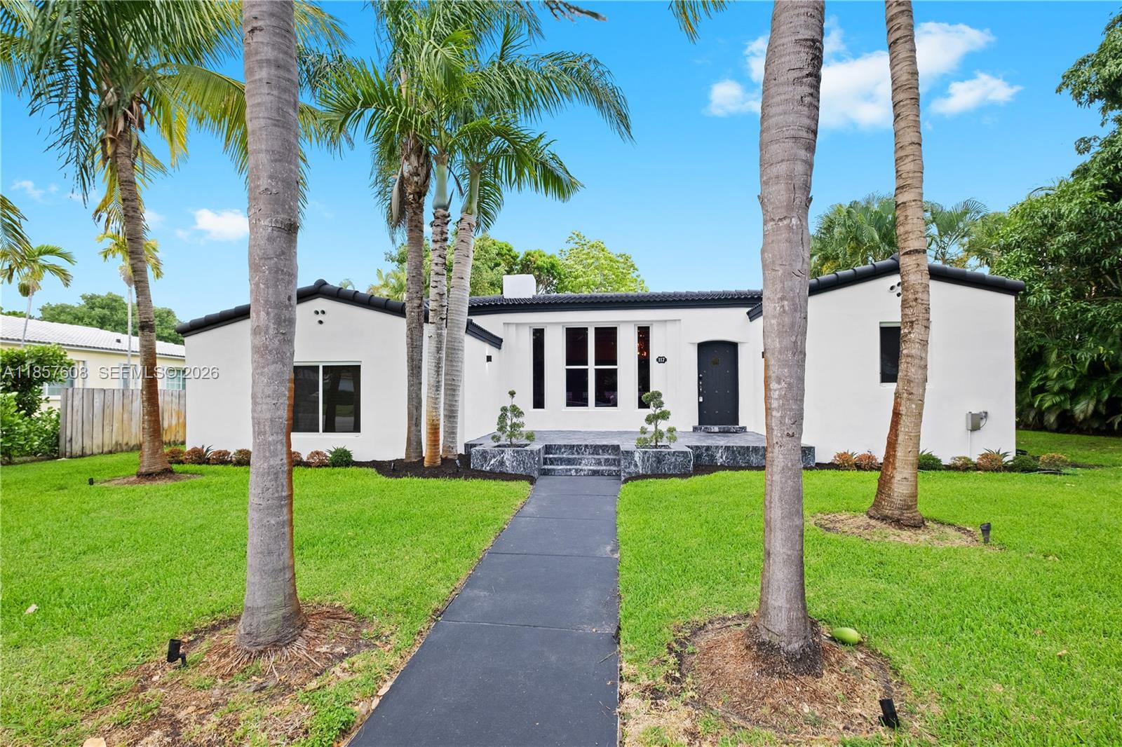 Welcome to this meticulously renovated Modern home in highly sought after Miami Shores! Boasting a total of 4 Beds/ 3 Baths, this exquisite property offers just under 3,000 sqft under AC, including a separate, beautifully renovated in-law quarters for added versatility and convenience. Step inside to discover soaring ceilings ranging from 10-12 feet throughout the entire home, creating a spacious and luxurious ambiance. The centerpiece of the living area is a real wood-burning fireplace, perfect for cozy evenings and gatherings with loved ones. Additional highlights include a 500sqft finished garage, providing endless possibilities as a pool/game room, gym, or additional garage space.