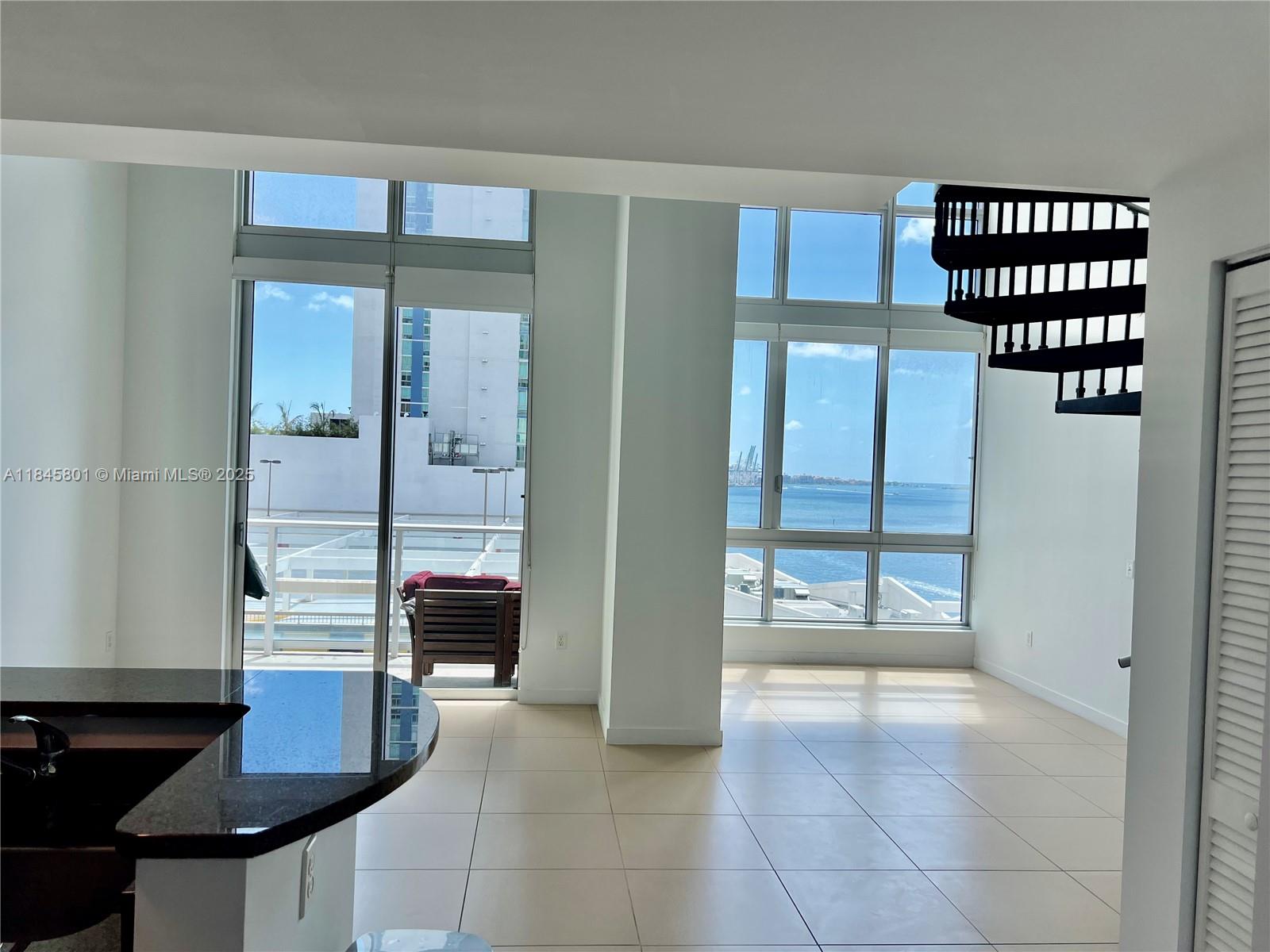 Rare opportunity to lease a two-story loft in Met 1, located in the most coveted loft line of the building—with wider proportions than any other loft line and breathtaking views over Biscayne Bay. Expansive East-facing floor-to-ceiling windows. Dramatic 19'4" ceiling heights. Tile floors throughout. Black out shades in all windows. Striking spiral staircase. Water, basic cable and Internet included. Brand new LifeFitness equipment coming soon. One assigned parking space on the same floor! Walk to Whole Foods Market, Bayfront Park, metro mover, Novikov Bar & Grill Restaurant, Joe and the Juice, Hell's Kitchen restaurant by Gordon Ramsay, plus 17 screens' Silverspot Cinema. Chic downtown living at its best!