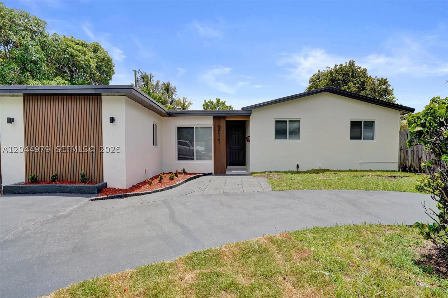 Turnkey Modern Living on an Oversized Corner Lot with Impact Windows and Newer Roof!

Welcome home to this beautifully renovated 4-bedroom, 2-bath residence where contemporary design meets everyday comfort. Situated on a desirable CORNER LOT ALMOST 1/4 ACRE, this MOVE-IN-READY home offers exceptional indoor and outdoor living with room to create your dream backyard oasis.

The OPEN-CONCEPT FLOOR PLAN is anchored by a STUNNING KITCHEN featuring QUARTZ COUNTERTOPS, an EXPANSIVE DINING PENINSULA, designer pendant lighting, BRAND-NEW STAINLESS STEEL APPLIANCES, and a SAMSUNG SMART HUB REFRIGERATOR—perfect for entertaining.

The SPACIOUS PRIMARY SUITE offers a walk-in closet and spa-inspired ENSUITE BATH a large walk-in shower, elegant tilework, matte black fixtures, and a backlit LED mirror. The renovated guest bath features a SOAKING TUB, designer finishes, and an LED mirror.

Additional upgrades include IMPACT WINDOWS, four generously sized bedrooms, a utility/laundry room, and a NEWER ROOF replaced in 2013.

Enjoy the HUGE FENCED BACKYARD with a LARGE PATIO for outdoor dining and grilling. The OVERSIZED SIDE YARD offers plenty of room for a pool, playground, RV or boat.

Designer finishes, modern upgrades, and an oversized lot make this exceptional home the perfect blend of style, comfort, and functionality.