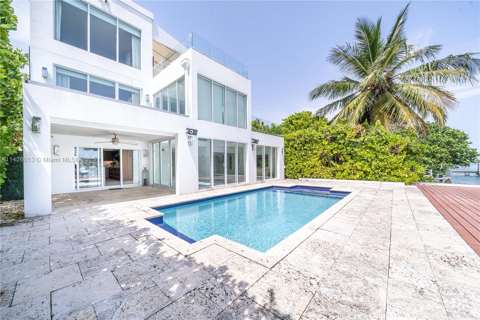 A modern and impressive bay front  house in the prestigious Palm Island exclusive community gated and police patrolled. Available, vacant. Four bedrooms ovelooking the bay with ample decks and balconies, plus an office, studio or gym. It has a detached utility bedroom and storage space. Inside the gated driveway can be acomodated 4 cars and 2 more in the garage. Full kitchen with viking appliances, hurricane impact glasses throughout. Shades and curtains with automated system and smart house operation. heated pool, ample deck equiped with a boat or jet sky lift, private dock for up to a 75 yatch, easay to show, please text listing agent.