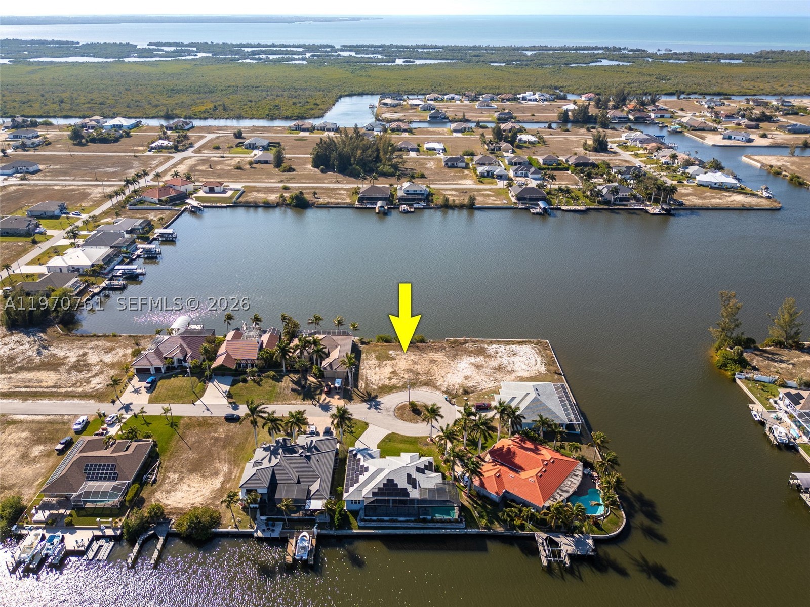 This direct Gulf access waterfront lot in Northwest Cape Coral offers 112 feet of canal frontage on a wide, direct-access canal with no bridges to the Gulf of America via the Matlacha Pass. Located on a quiet cul-de-sac in a neighborhood just off Old Burnt Store Rd, this buildable canal-front lot is the perfect opportunity to design and construct your dream home in one of Cape Coral’s fastest-growing boating communities. Boaters will appreciate the wide canal that can accommodate a variety of vessel sizes and allows for a custom dock and lift tailored to your needs. Enjoy boating to waterfront dining at Miceli’s or Yucatan Waterfront Tiki, fishing the mangroves of Matlacha Pass or cruising to open water while spotting the ever-present dolphins and manatees along the way. This waterfront lot is also positioned nearby the future Seven Islands development, officially approved by the Cape Coral City Council and projected to include a marina, hotel, amphitheater, dog park & more - making this not just a lifestyle purchase, but a strategic investment opportunity in Northwest Cape Coral. Less than three miles away, newly completed Crystal Lake Park offers walking trails, freshwater fishing, playgrounds, and green space, adding everyday convenience to your waterfront lifestyle. If you’ve been searching for a direct Gulf access lot on a wide canal in Cape Coral where you can build your custom dream home, this is your opportunity to create the ultimate Southwest Florida tropical oasis.