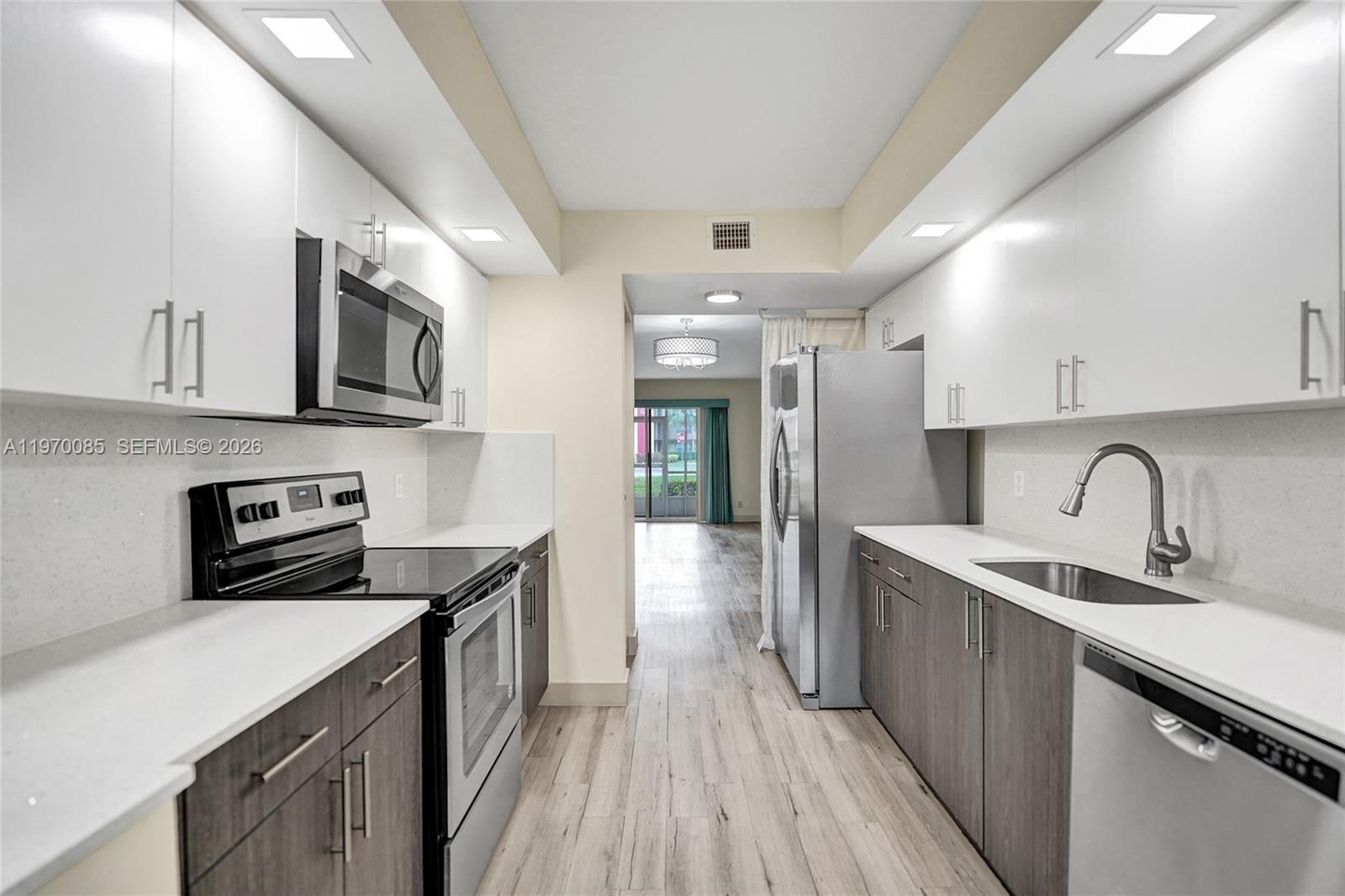 Experience resort-style living in this stunning, 1st-floor Karanda model featuring 1,351 sq. ft. of living space—This unit features modern, wood-look laminate flooring throughout (no carpet!).

The designer kitchen boasts newer cabinetry, sleek Corian countertops, and premium stainless steel appliances. Both spacious bedrooms include large walk-in closets, and the bathrooms have been fully updated with contemporary vanities. For ultimate convenience, a full-size washer and dryer are located inside the unit.  650 credit score.  No rental restrictions.  Application fee $150 per person including married couples - must show proof of marriage. 

The monthly association fee is all-inclusive, covering water, trash and sewer. Located in a premier 55+ community, residents enjoy a million-dollar clubhouse, two fitness centers, multiple pools, tennis, golf, a theater, on-site pharmacy, and a community bus.