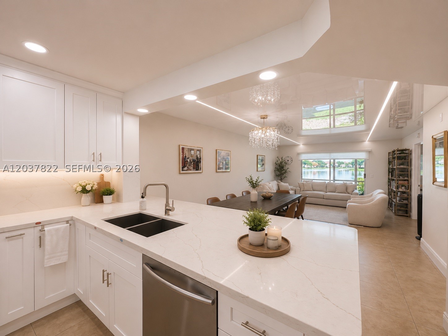 Beautifully updated first floor 2 bedroom, 2 bathroom waterfront Jasmine model located in the newer section of Century Village Pembroke Pines, featuring breathtaking lake and fountain views. The spacious open concept kitchen showcases a large center island, quartz countertops, full quartz backsplash, and wood cabinetry. Both bathrooms have been tastefully renovated with modern finishes.
A unique and elegant stretch ceiling enhances the open living and dining areas, adding a sophisticated contemporary touch to the home. The bright and spacious living spaces overlook the water, creating a peaceful setting perfect for relaxing or entertaining.
Enjoy resort style living in Century Village, one of South Florida's premier 55+ communities, offering a magnificent clubhouse, courtesy transportation, fitness centers, indoor and outdoor pools, tennis courts, golf, movie theater, billiards, pharmacy, café, social activities, and countless amenities.