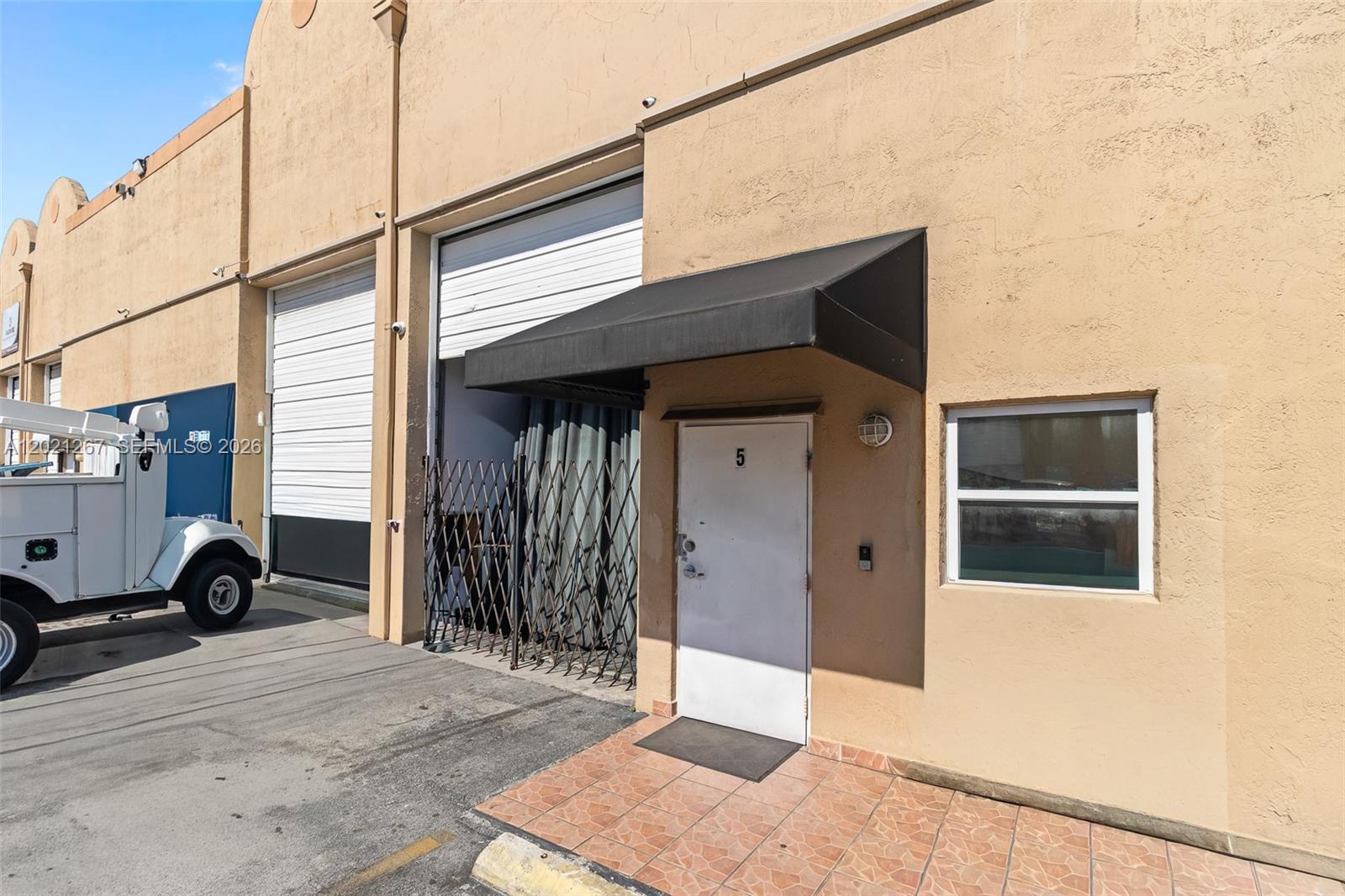 Rare opportunity to own a highly built-out industrial condo in Hialeah's thriving commercial corridor. This 1,160 SF unit features a welcoming reception area, multiple private offices, a fully equipped kitchenette with wood cabinetry and granite countertops, two full bathrooms with showers, and security gating throughout — truly move-in ready for a wide range of business operations.
The warehouse bay boasts soaring 20-foot ceilings, pallet racking in place, and an oversized overhead drive-in door — ideal for storage, distribution, light manufacturing, and trades. The quality of the build-out eliminates the need for costly tenant improvements.
Minutes from the Palmetto Expressway on-ramp and Okeechobee Road, with seamless access to all of Miami-Dade and Broward. Directly across from Lowe's and Target.
Low monthly HOA covers building structure and roof. Ideal for contractors, logistics operators, small business owners, or 1031 exchange buyers.
Exceptional value in a tight industrial market — schedule your showing today.