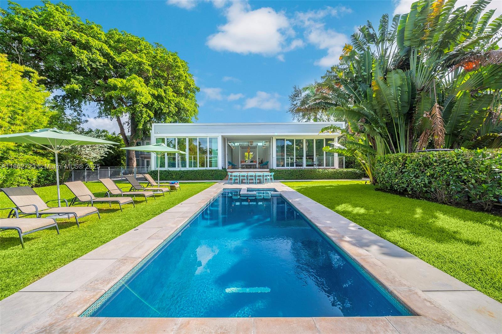 Villa Tulum is a waterfront retreat in Miami’s sought-after Upper East Side, where modern comfort blends with a
tropical lifestyle. Located on an 11,000 sq.ft. lot, this 2017-built estate is designed for seamless indoor-outdoor
living. The main residence offers an airy open-plan living and dining area, sleek kitchen, 4 bedrooms, and a breezy covered patio. A detached two-story guest house includes a 2-bedroom loft with kitchen and bath+maid’s quarters and storage. Outdoors, lush gardens surround an infinity pool overlooking the Miami River, complemented by a new private dock for boats up to 65 feet with direct access to the bay. Ready to move in, this property is perfect for those seeking a tranquil primary home, a vacation escape, or a smart investment in a rapidly growing neighborhood.