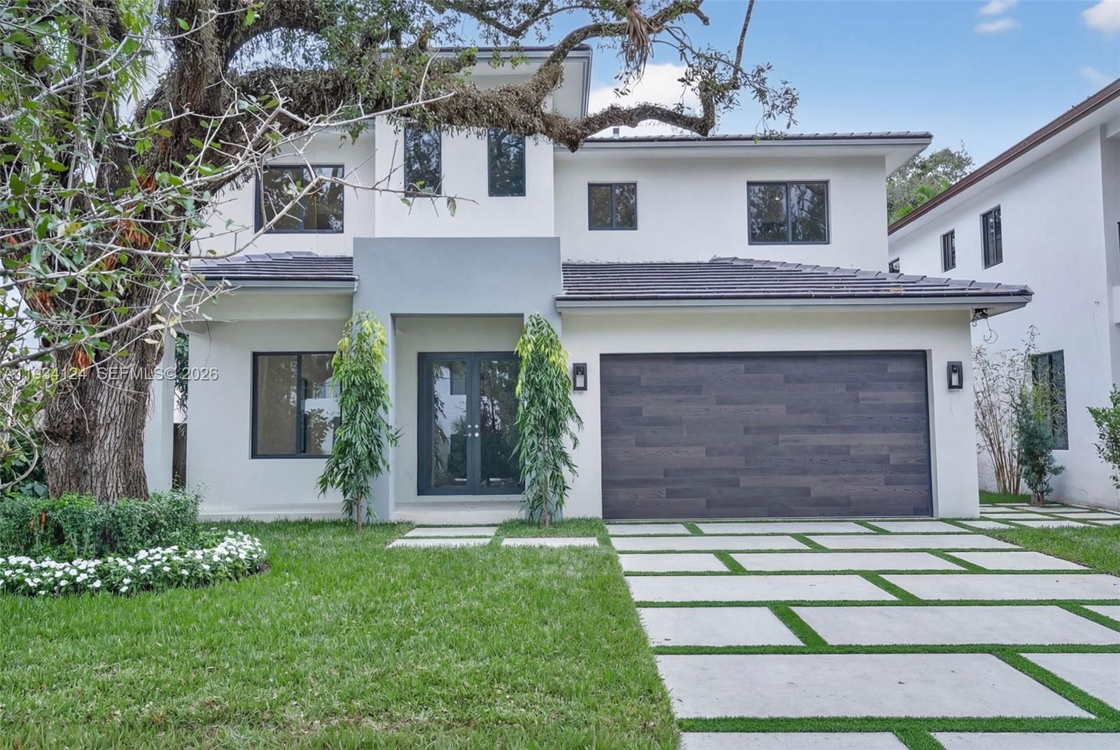 Exceptional residence ideally positioned just minutes from South Miami, offering a seamless blend of timeless design and modern functionality, with convenient proximity to shopping and schools. The custom white oak kitchen is finished with elegant Taj Mahal quartzite countertops and equipped with top-of-the-line Jenn-Air appliances.

Bathrooms feature bespoke vanities topped with Taj Mahal quartzite and natural marble shower walls. The primary bath is designed as a private sanctuary, highlighted by premium fixtures and a refined, spa-like feel.

**The images has been digitally altered for virtual staging.