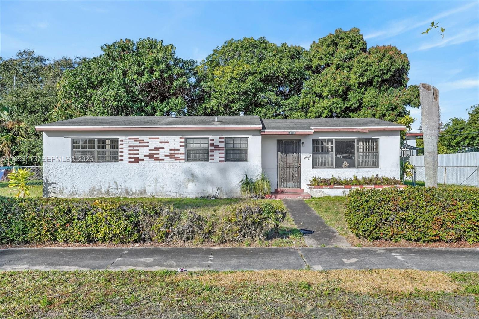This single-family residence features three bedrooms and two bathrooms, established on a lot of over 8,000 square feet with 1,137 square feet of living space in Miami Gardens. The backyard offers significant potential for customization, including ample space for a pool, outdoor entertainment area, and existing fruit trees. The property is being sold As-Is, with pricing reflective of the need for minor cosmetic updates and repairs. It is conveniently located near major highways, shopping centers, and dining establishments.
