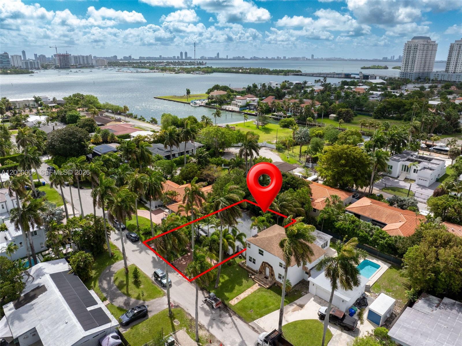 Tucked away in the hidden enclave of Davis Harbour next to East Miami Shores, this 3 bedroom, 2 bathroom home is located only 1/2 block from Biscayne Bay, offering a peaceful coastal lifestyle with morning walks by the bay just steps away. Originally developed in the 1940s–1950s as a quiet bay-adjacent community,  Davis Harbour has preserved its low density charm and Old Miami character. Inside, a spacious layout features tile flooring throughout and a striking brick accent wall that adds warmth and character. The large kitchen offers wood cabinetry and Samsung appliances, ideal for everyday living and entertaining. Bathrooms have been updated, and this turn key fully renovated home is move in ready with impact windows and doors, a newer roof, fairly new AC, and freshly painted interior and exterior. EV charging station, plus plenty of parking available in the driveway. Just minutes to the Design District, Wynwood, and Downtown Miami and the beaches. Rare opportunity in a location that continues to appreciate. EASY TO SHOW!
