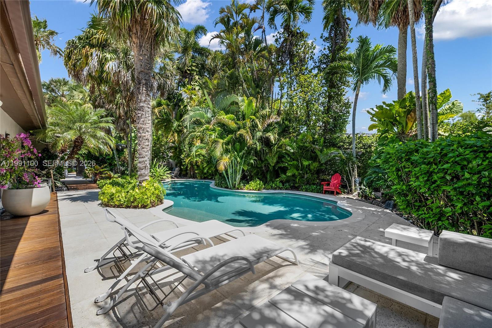 Quintessential charming South Grove gem nestled on a tree canopied cul-de-sac. Enter into a captivating tropical garden that embraces the home, 42 FT lagoon style pool and inviting outdoor spaces. Enjoy the sunlit living room, dining room and glass roof screened patio for the ultimate Florida indoor/outdoor lifestyle. In addition to the 3 bedrooms there is a flex space for a 4th bedroom, office or gym. Special features include an expansive 10,400 FT lot, privacy wall, remodeled kitchen and bathroom, fire pit, vegetable garden and impact windows/doors. Close to top-tier schools, marinas and restaurants.
