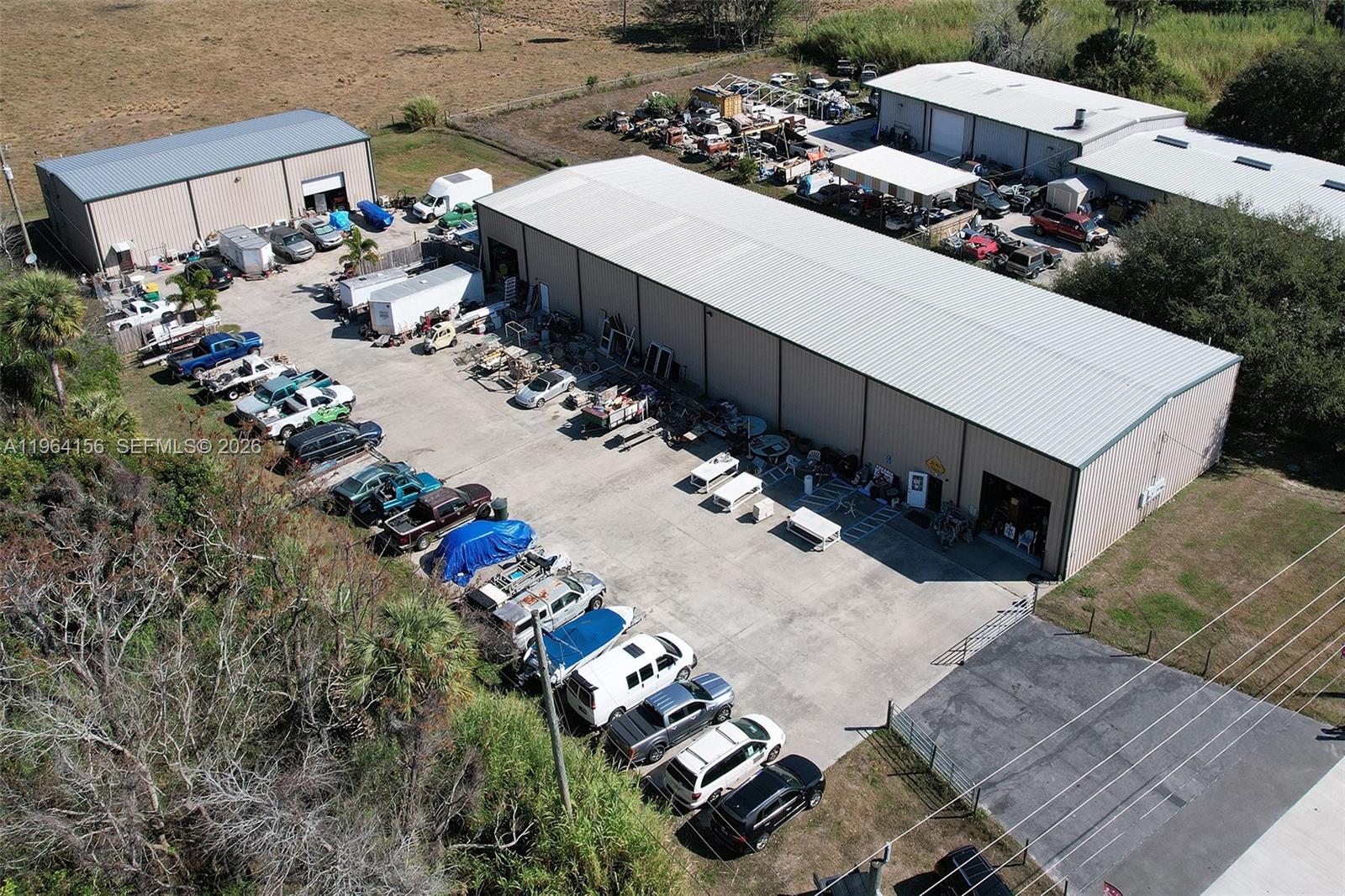 Rare opportunity to acquire a highly versatile heavy commercial property with exceptional frontage, visibility, and functionality along US Highway 441. Includes about 11,000 sq ft of improvements across two standalone structures on a 1.23+ acre lot. Two warehouses approximately 8,000 sq ft and 3,000 sq ft. Large concrete paved parking and yard area. Seller willing and able to remove all items and inventory from both buildings. Primary structure features open floor plan and may be configured into multiple bays depending on needs. The second building is currently setup for mixed-use occupancy such as live/work or office use and storage. 

Calling all investors or owner operators. Exceptional property for indoor and outdoor storage, contractors, distribution, sales, fleet parking, retail, compound use, or owner-users. Property has new septic tank system as well as city water and electric. Seller is MOTIVATED and open to BEST OFFER.