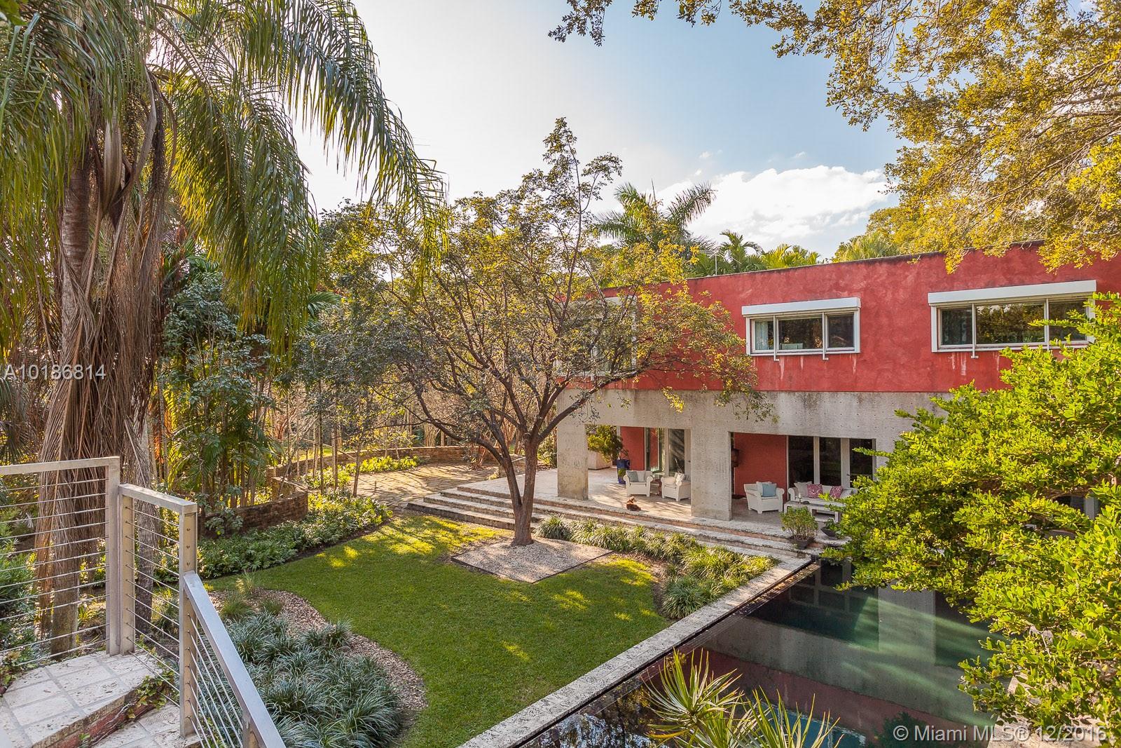 This award-winning, published residence sits on 2 extraordinary acres providing the ultimate retreat for the sophisticated nature enthusiast. Unlike anything on the market today, this family compound is anchored by a contemporary 5 bed/4.5 main home, surrounded by multiple guest houses. With native flora to rival Fairchild Gardens, the infinity pool, lake, beach, bridge,courtyards & paths,all interplay with sun-kissed rooms. Resident fish & turtles are included in the sale in this once-in-a-lifetime home. A Very Special Home.