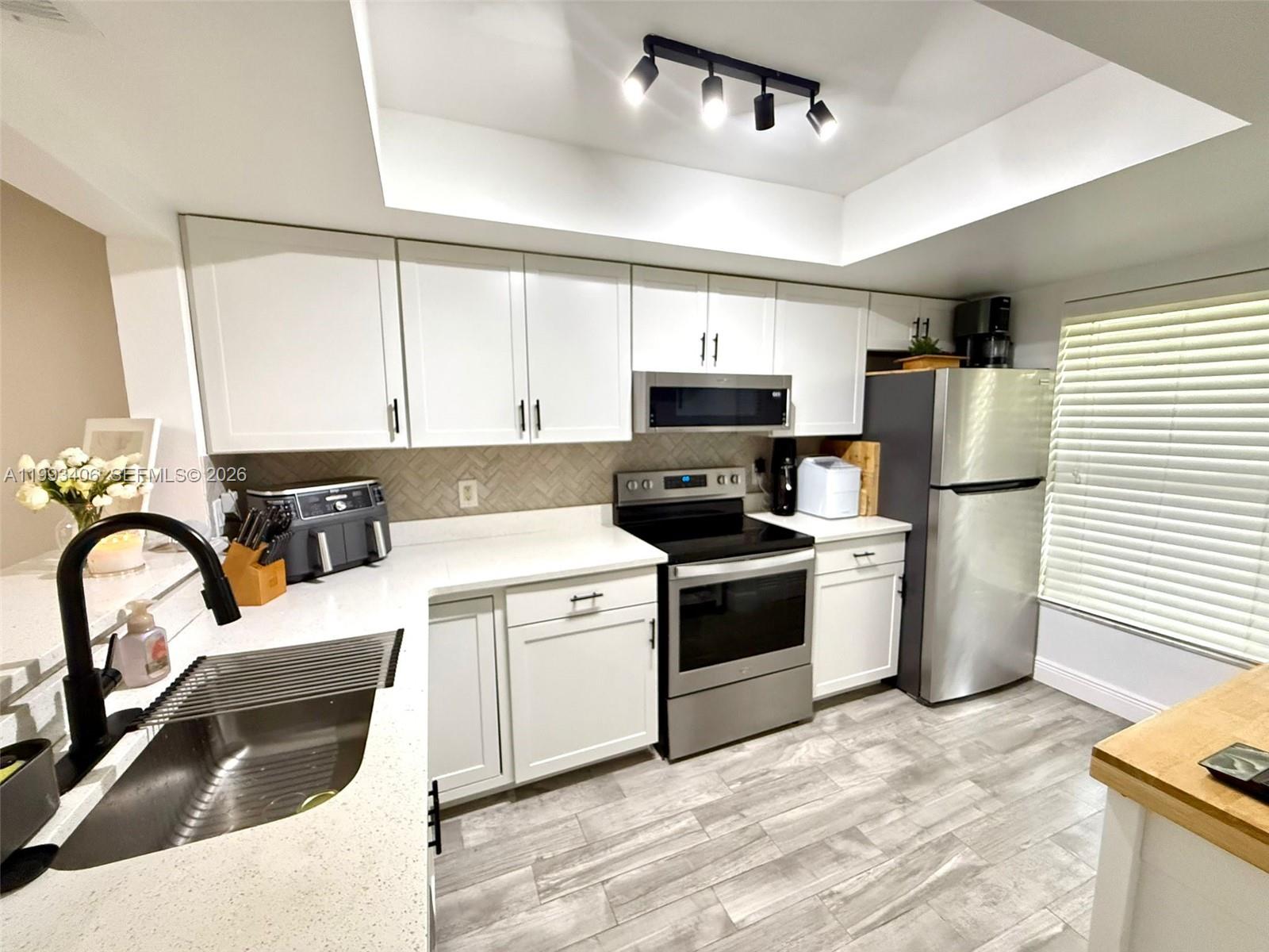 ALERT! Rarely available ground-floor 2/2 in the desirable Country Lakes community, just off Keene Rd. This fully remodeled, ground-floor unit is truly move-in ready, featuring tile floors in the living areas, kitchen, and carpet in the bedrooms. Split layout for added privacy, and an open concept living and dining area. You'll love the kitchen space, primary suite boasts ample storage, including a large walk-in closet. Enjoy the pool views from the large, screened lanai or step right outside to the community pool. In-unit W&D, covered parking, and a storage room are included, along with water, sewer, and cable TV in the HOA. New roof in 2024 with no Pending assessment. This unit reflects pride of ownership from the moment you walk in. Come see it for yourself – you won’t be disappointed!