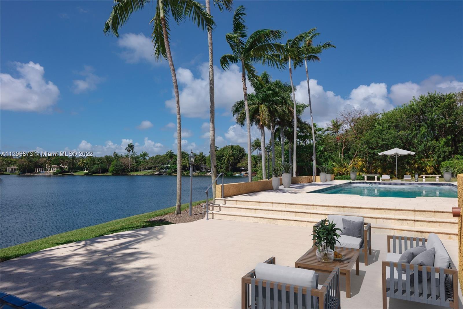 Welcome to Casa Arancióne, a rarely available lakefront estate on prestigious Hammock Lake. The gated property sits on an expansive 34,000sqft lot with multiple courtyards and terraces. At the end of the driveway is an inviting Mediterranean fountain that leads to the main entrance of the home. Built by renowned architect Giorgio Balli, the home is split into 5 bedrooms in the main house and a 1/1 guest quarter connected by a breezeway. It was designed to have gorgeous water views from every angle. The large terraces, rolling green lawns, and summer kitchen overlooking the swimming pool and lake make it perfect for entertaining. The property includes a country kitchen with gas cooktop, butler's pantry, fireplace, 3 car garage, generator, and much more.