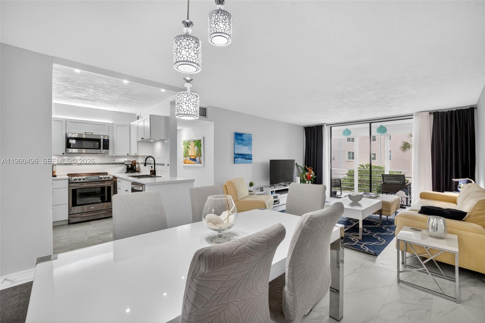 Stunning, fully remodeled corner unit in the HOPA-verified community of Somerset Phase 1, Building G. This beautifully furnished 1-bedroom, 1-bath residence is offered turnkey and features abundant natural light, new tile flooring throughout, and a modern open layout. The contemporary kitchen showcases white shaker cabinets, stainless steel appliances, and flows seamlessly into the living and dining areas. Major updates include a new roof, A/C (2017), and water heater (2023). 50 years is also complete! Enjoy peaceful garden views from the screened balcony with roll-down shutters, accessible from both the living room and bedroom. Community amenities include a heated pool, pickleball, sauna, fitness center, clubhouse, billiards, library, shuffleboard, and more. Move-in ready!