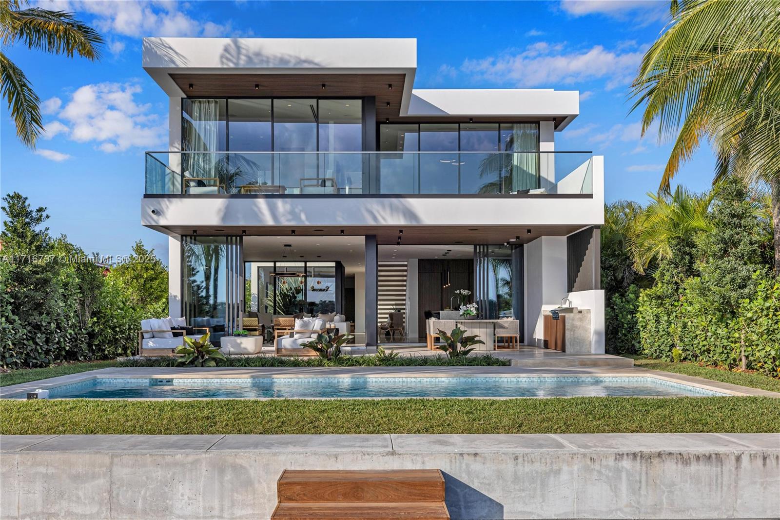 Overlooking Biscayne Bay with magnificent sunsets, this brand new, never-lived-in home features 4 bedrooms and 4.5 baths over approximately 4,000 SF under A/C, plus a large 2-car garage, pool, and boat dock. With its modern design and attention to detail rarely seen, this home will leave you speechless. Situated on a gated island, enjoy 50 feet of waterfront, ocean access, and bay views—great for boaters. Conveniently located within walking distance to the beach and nearby schools, this is a true sanctuary in a prestigious community.