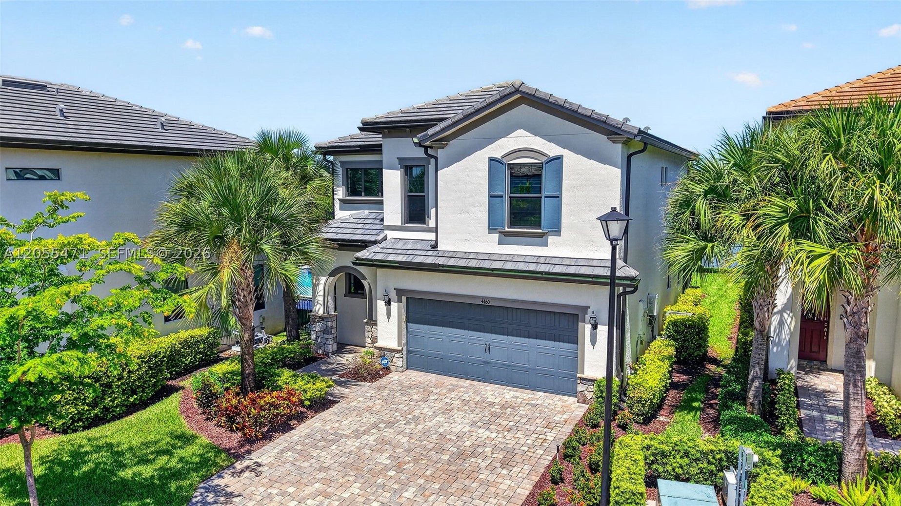 Experience refined LAKEFRONT LIVING in this 2022-built Alexander model home, perfectly positioned on a quiet cul-de-sac within the gated OAK TREE community. This beautifully appointed residence offers 3 bedrooms plus a loft, 2.5 baths, and an open, light-filled floor plan designed for effortless South Florida living. The designer kitchen showcases white shaker cabinetry, quartz countertops, stainless steel appliances, gas range, a walk-in pantry, and a generous island/serving bar. Upstairs, the elegant primary suite features an oversized walk-in California closet with custom shelving and spa-inspired bath with a dual sink vanity, designer tilework, extended shower with built-in bench seating. Additional highlights include spacious guest rooms, a 14' x 13' loft/game room, second-floor laundry with cabinetry and utility sink, designer tile flooring, plantation shutters, LED lighting, IMPACT WINDOWS and DOORS, and a 2-car garage with epoxy flooring, workbench, modular cabinetry, and overhead storage. Outdoors, unwind on the EXTENDED SCREENED COVERED LANAI overlooking wide LAKE and FOUNTAIN VIEWS. Residents enjoy resort-style amenities including clubhouse, fitness center, pool, cabanas, BBQ grills, fire pit, hammock oasis, dog park, playfield, and pickleball courts. HOA includes landscaping and fiberoptic internet. Minutes to premier shopping, dining, world famous beaches, Las Olas, downtown Fort Lauderdale, travel and more.
