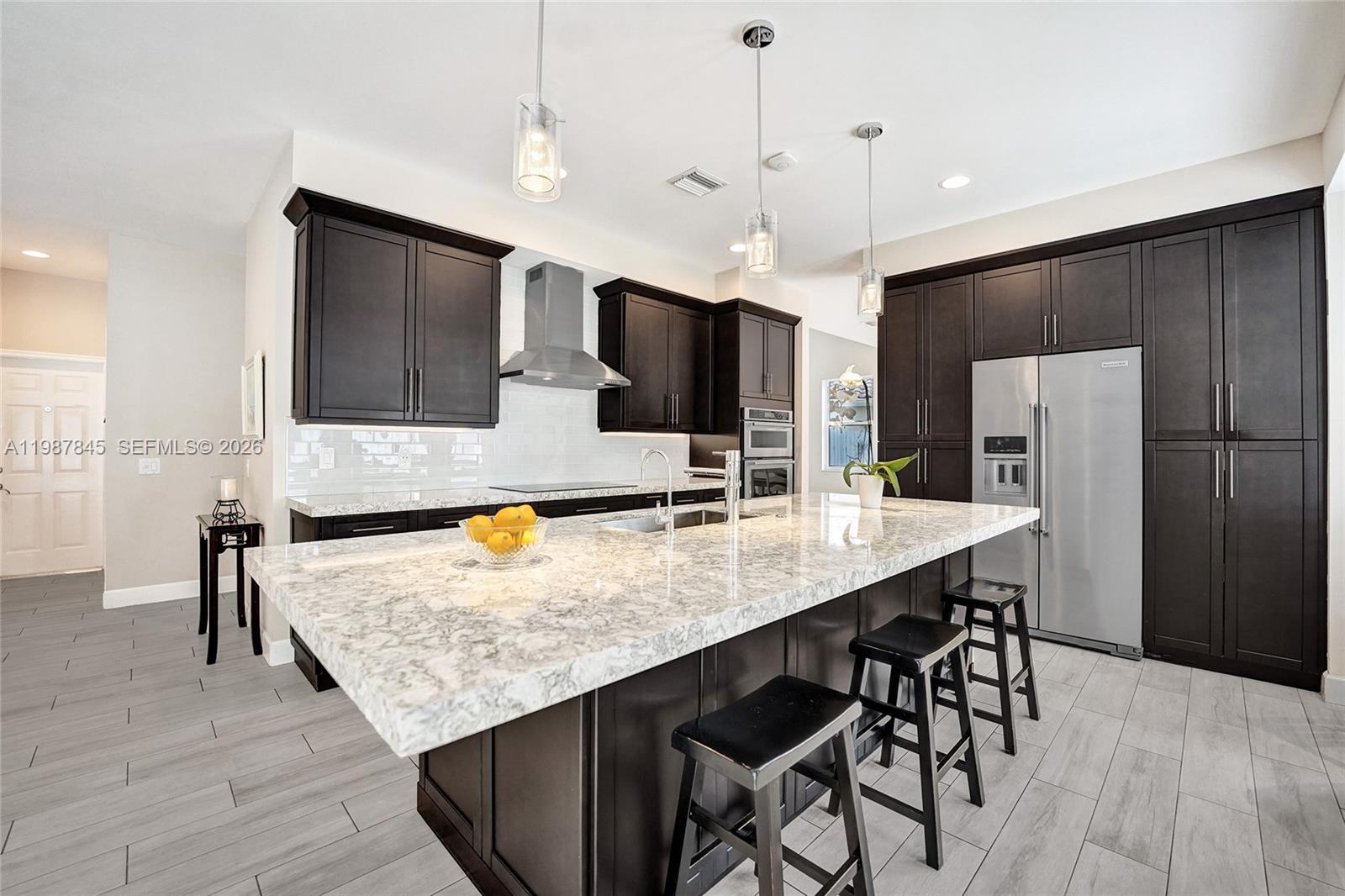 Welcome home to a place that blends thoughtful design with understated elegance.
Located in the heart of Weston with access to A-rated schools, this 4-bedroom, 2.5-bath home is designed for connection, comfort, and creating lasting memories.

At the center of it all is a beautifully remodeled kitchen that opens seamlessly to the family room; perfect for entertaining, family dinners, or simply enjoying a quiet night in while staying connected. Step outside to a spacious lake-view backyard with plenty of room for kids to play, guests to gather, and sunrises to unwind.

The kitchen truly shines as the heart of the home, featuring high-end stainless steel appliances, custom cabinetry to the ceiling, and an oversized island with seating for six. The countertops are Cambria Berwyn, elegant with a subtle sparkle, a perfect reflection of the home itself. A charming breakfast nook completes the space, overlooking a stunning view. Coffee in hand, sunrise in view...moments like this are priceless.

Upstairs, the primary suite offers more than just a place to rest, it includes a flexible space ideal for a home office, workout area, or a cozy reading nook. With impact glass throughout, a 2019 roof, and fresh exterior paint, this home is move-in ready and waiting for its next chapter.

All that’s missing is for you to make it yours.