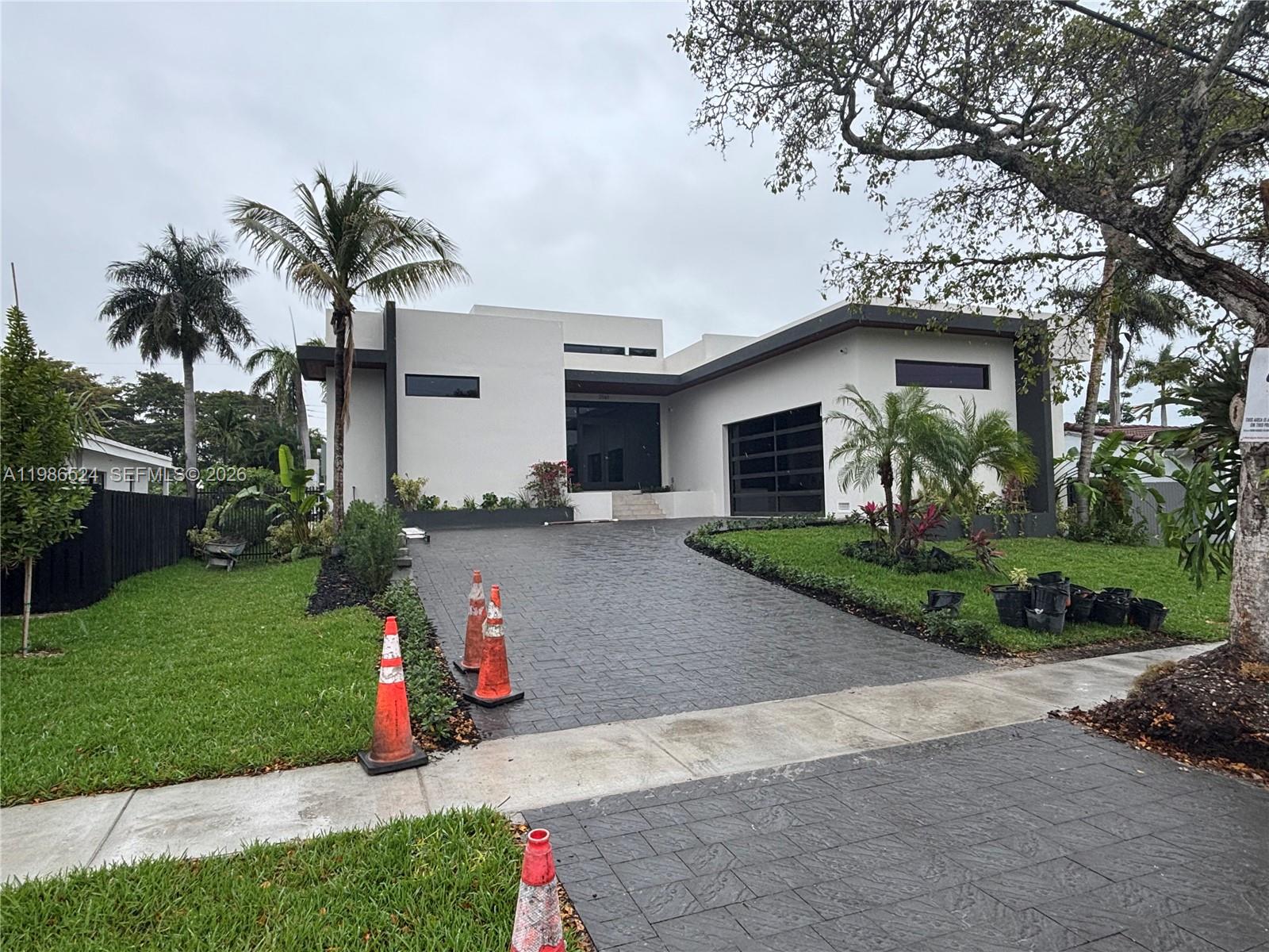 Miami Modern New Construction. Here is the opportunity to move into a brand new modern single level 5 bed, 5.5 bath, 2 car garage home. Features soaring 18' ceilings surrounded by windows on all sides in the Living and Family Room. All bedrooms are ensuite with 12' ceilings. Imported 4' x 4' porcelain tiles throughout the home. The custom European finished Kitchen is a chef's delight with natural gas 48' Wolf stove/ oven and 48" Subzero refrigerator. To entertain we also have a full wet bar and beverage/wine refrigerator. The covered patio terrace includes a built-in natural gas grill, refrigerator and sink for alfresco cooking and entertaining. The patio terrace overlooks the tropical pool surrounded by landscape. See attached photos of the home in its completion stage.