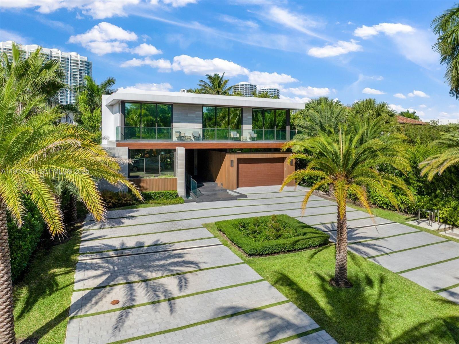 Completed in 2024, this newly built modern masterpiece in coveted Golden Beach offers exceptional craftsmanship, striking design, & a tranquil outdoor oasis created for waterfront living. Sitting on a 10,476 SF lot, this 6,773 total SF residence welcomes you with an oversized driveway & grand architectural entry framed by floating steps.  Inside, features a Mia Cucina kitchen w/ Taj Mahal stone, limestone floors on the main level, warm wood upstairs, frameless doors, high end light fixtures, Cristallo stone bar, and Control 4 smart home system w/ Lutron lighting. The spacious primary suite showcases dual walk-in closets and large terrace capturing stunning sunsets. Elevator, pajama lounge & wine room complete the sophisticated interior. 45 feet of water frontage, private dock, Sub-Zero & Wolf summer kitchen, & outdoor shower create a true resort setting.