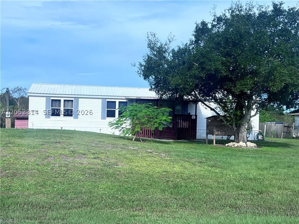 Escape the city and embrace the tranquility of rural life with this charming 4/2 manufactured home located in the heart of LaBelle! Built in 1998, and 1,440 sq. ft. this solid home features a durable metal roof, spacious interior, and sits on half an acre perfect for outdoor enthusiasts, gardeners, or anyone looking for room to spread out. This home is ideal for those who crave peace, privacy, and plenty of yard space. Whether you're dreaming of raising chickens, planting fruit trees, or simply enjoying the stars at night without city lights this home makes it possible.