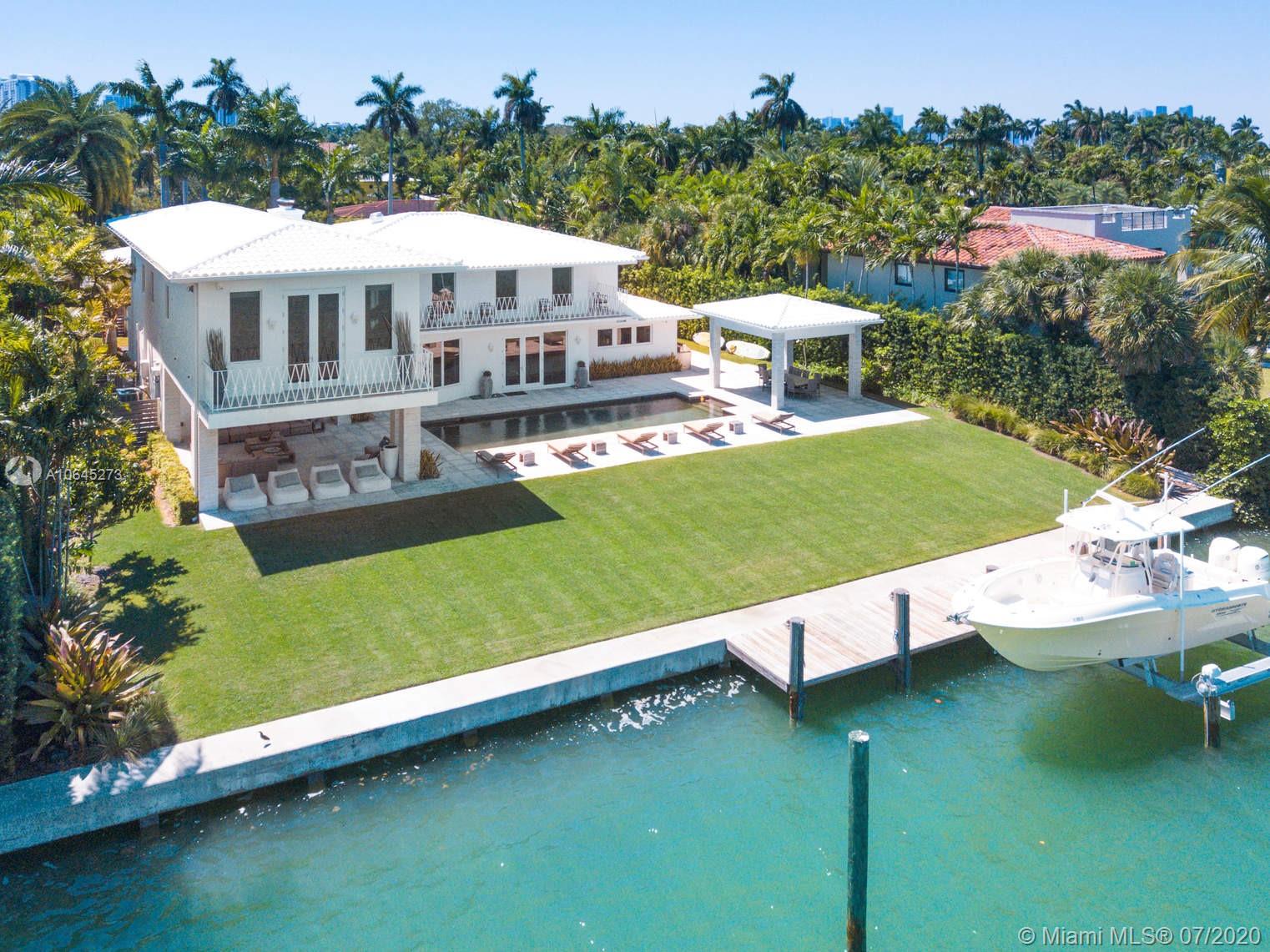 Elegantly restored bay front mid-century estate on prestigious Sunset Island I. Contemporary and elegant interiors with marble and hardwood floors. Luxurious finishes throughout. Master bedroom sanctuary, office, morning kitchen, walk-ins and spa bathroom. Chef's kitchen with top of the line appliances. Designer bathrooms. Landscaped courtyard entrance through loggia. Separate gym house, fully equipped summer kitchen with heated pool overlooking the wide bay. Alfresco dining, brand new dock, generator, brand new irrigation well system. Casual elegance, chic interiors, leisurely resort style island living in the heart of Miami Beach.