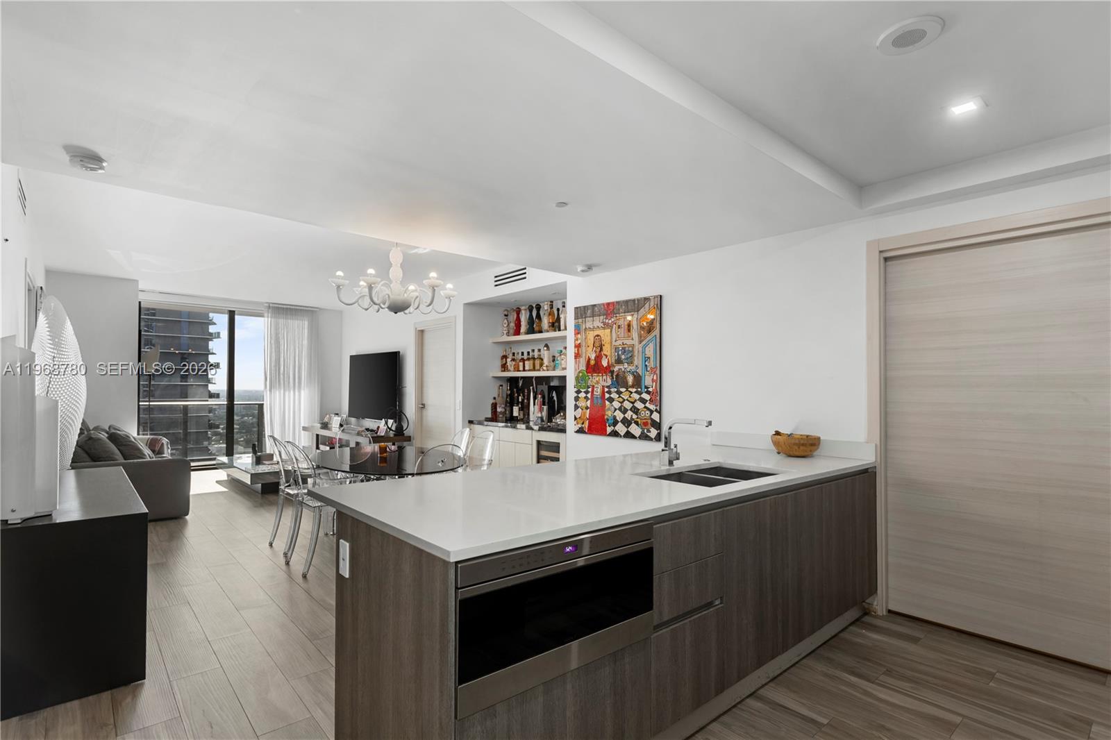Spectacular condo at SLS LUX featuring private elevator entry, soaring ceilings, and a well-designed layout with 2 bedrooms, 2 bathrooms, and a spacious den—perfect for a home office or media room. Enjoy an upgraded bar area with marble countertops, ideal for entertaining. The condo also includes a large laundry room and pantry. The master suite offers a built-in closet and a luxurious bathroom with a separate shower and soaking tub. Beautiful porcelain floors run through the condo, adding warmth and style. The chef’s kitchen is outfitted with premium Wolf, Bosch, and Sub-Zero appliances and sleek Italian cabinetry. Residents enjoy exceptional services including room service, a spa, and 24-hour concierge. Located directly across the street from Brickell City Centre.