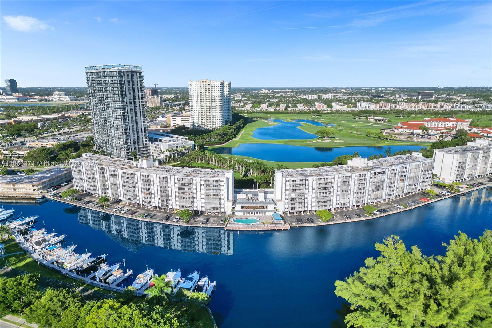 Spacious 1 bedroom, 1.5 bath unit with stunning golf course views in a fantastic location. Recently renovated with a brand-new kitchen, tile flooring, and new impact windows and doors. Enjoy the charming enclosed balcony—ideal for extra living space or a quiet retreat. Building offers excellent amenities: bayfront pool, gym, BBQ area, and rooftop terrace with panoramic views. Walk to shops, restaurants, and more. Only 10 minutes to the beach. Assigned parking space included. Perfect for year-round living or as a vacation getaway!