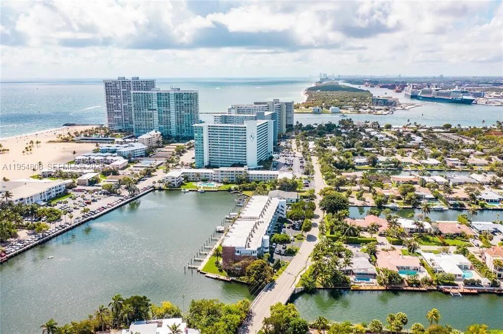 This spacious condo features an open floor plan, allowing natural light to fill the living spaces. The kitchen is equipped with stunning onyx countertops, quality appliances, and ample cabinetry. Enjoy serene Lake Mayan views from the balcony. The geothermal pool provides year round relaxation. Turn key in the most desirable million $$ neighborhood! Located across the street from the widest beach in town and directly on Lake Mayan with direct access to the Intercoastal and ocean. Delightful community with beautiful, private grounds, heated and cooled pool, and boat dock. Across the street from Lago Mar Resort. No renting in the first year of ownership.