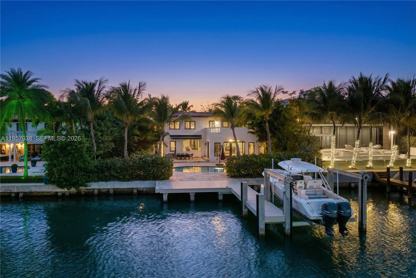 Escape to the pinnacle of privacy in this guard-gated Miami Beach enclave. Set on a sprawling 16,200-SF lot, this Mediterranean estate commands 75 feet of coveted waterfront, complete with a private dock and 16,000-lb lift for the serious yachtsman. Enter through a romantic loggia into a world of refined luxury: a grand living room with fireplace, gourmet kitchen, and formal dining ready for lavish entertaining. The primary suite is a true retreat, boasting an oversized terrace with sweeping water views. Three additional suites plus a separate 1/1 guesthouse offer absolute privacy for VIPs or staff. perfectly positioned moments from La Gorce Country Club and the ocean. A rare waterfront trophy for the uncompromising buyer.