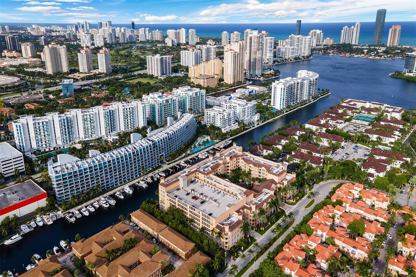 Stunning third floor condo with 2 bedrooms and  2.5 baths and a beautiful view overlooking the water. Gorgeous wooden floors throughout. This residence comes with a washer and dryer, 2 covered parking spots (149 and 151) and a large storage room (unit 369). Alaqua offers 5 star amenities: a newly renovated waterside dock, state-of-the-art fitness center overlooking the water, hot tub, pool, playground, business center, 24-hour security, valet and more. Just a short walk to Aventura Mall, Publix, restaurants and beaches. A+ rated schools and Brightline station at Aventura Mall is expected to be done by Fall 2021 to make travel even easier.