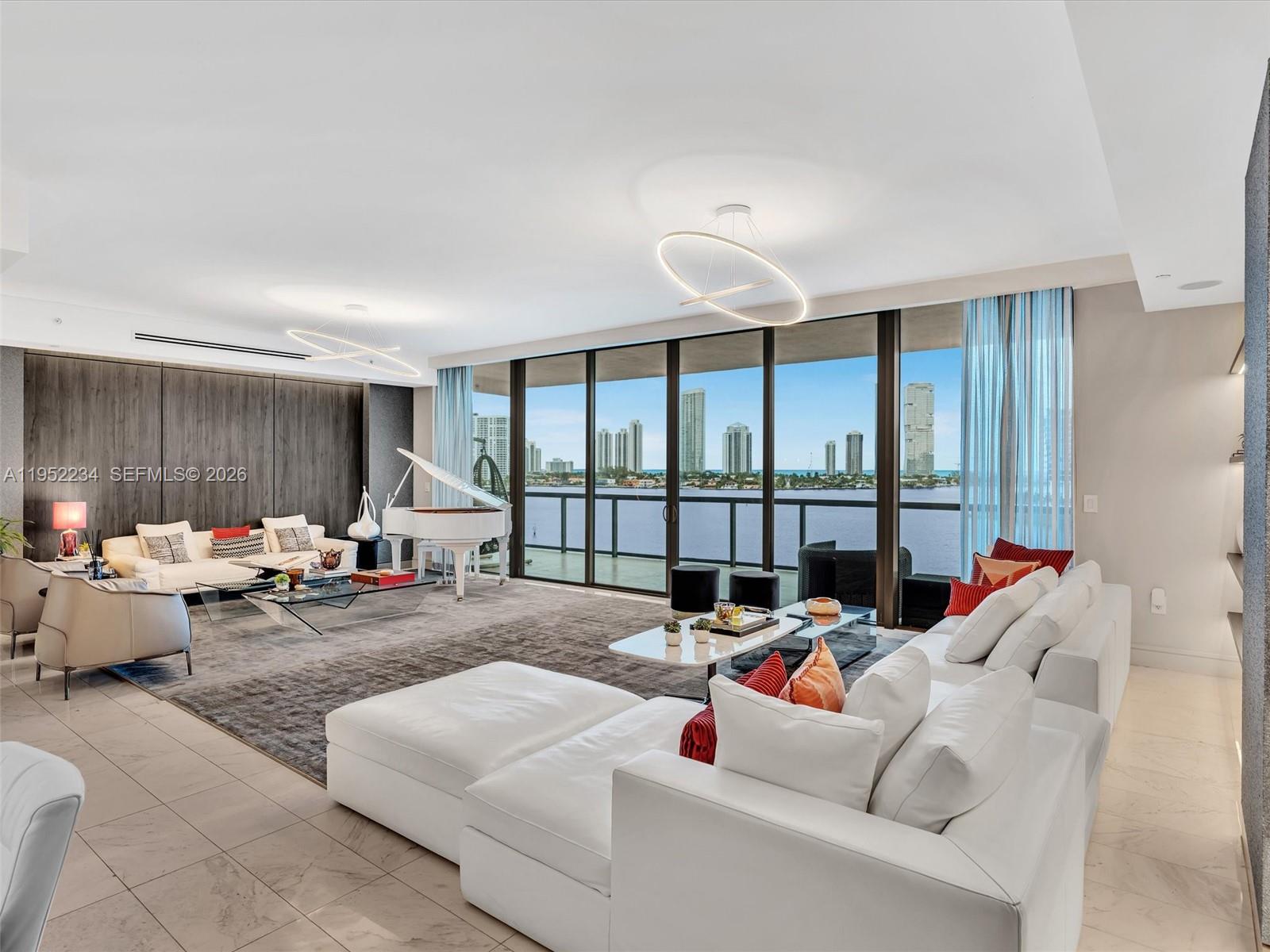 Arrive via private elevator to breathtaking ocean and bay views from this premier corner residence at Echo Aventura. Offering 3,801 SF of interior living space, the home is filled with natural light, enhanced by floor-to-ceiling glass and soaring ceilings. The residence features four bedrooms plus a den, 5.5 baths, and a separate service suite with full bath and laundry, ideal for staff quarters or flexible additional living space. Interiors curated by renowned designer Guimar Urbina showcase custom finishes and high-end materials throughout, with every detail thoughtfully tailored to perfection. Ideal for both everyday living and entertaining, the home includes a chef’s kitchen with Sub-Zero refrigeration and Wolf gas range, integrated smart-home technology with in-ceiling audio, and an expansive terrace with summer kitchen and BBQ. The primary suite offers a tranquil retreat with a generous walk-in closet and spa-inspired bath. Echo Aventura delivers true resort-style living with a bayfront infinity-edge pool, state-of-the-art fitness center with yoga studio, café/restaurant, dog services, and full-service luxury amenities