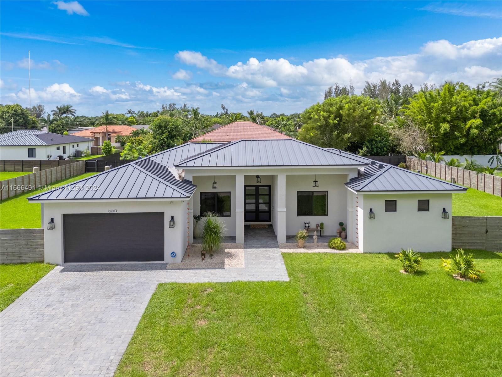 Welcome to the Redland's! Custom built home just completed in 2022. Sitting in an oversized 20,576 lot with an expansive layout and a total of 3,582 SF. This spectacular home features 5 bedrooms, 4 full bathrooms, a 2 car garage, metal roof, open concept layout, Italian porcelain flooring throughout, custom kitchen with stainless steel appliances, a water filtration system, huge master bedroom and master bathroom, large closets in all bedrooms, an oversized new salt water deep infinity heated pool with a spa/jacuzzi and a marble deck, all fenced in for privacy, hurricane impact windows and doors throughout the entire house, plenty of space to park a boat. Close to shopping, marinas, Keys and Miami Airport. Make it your very own private oasis, it's perfect for families and entertainers.