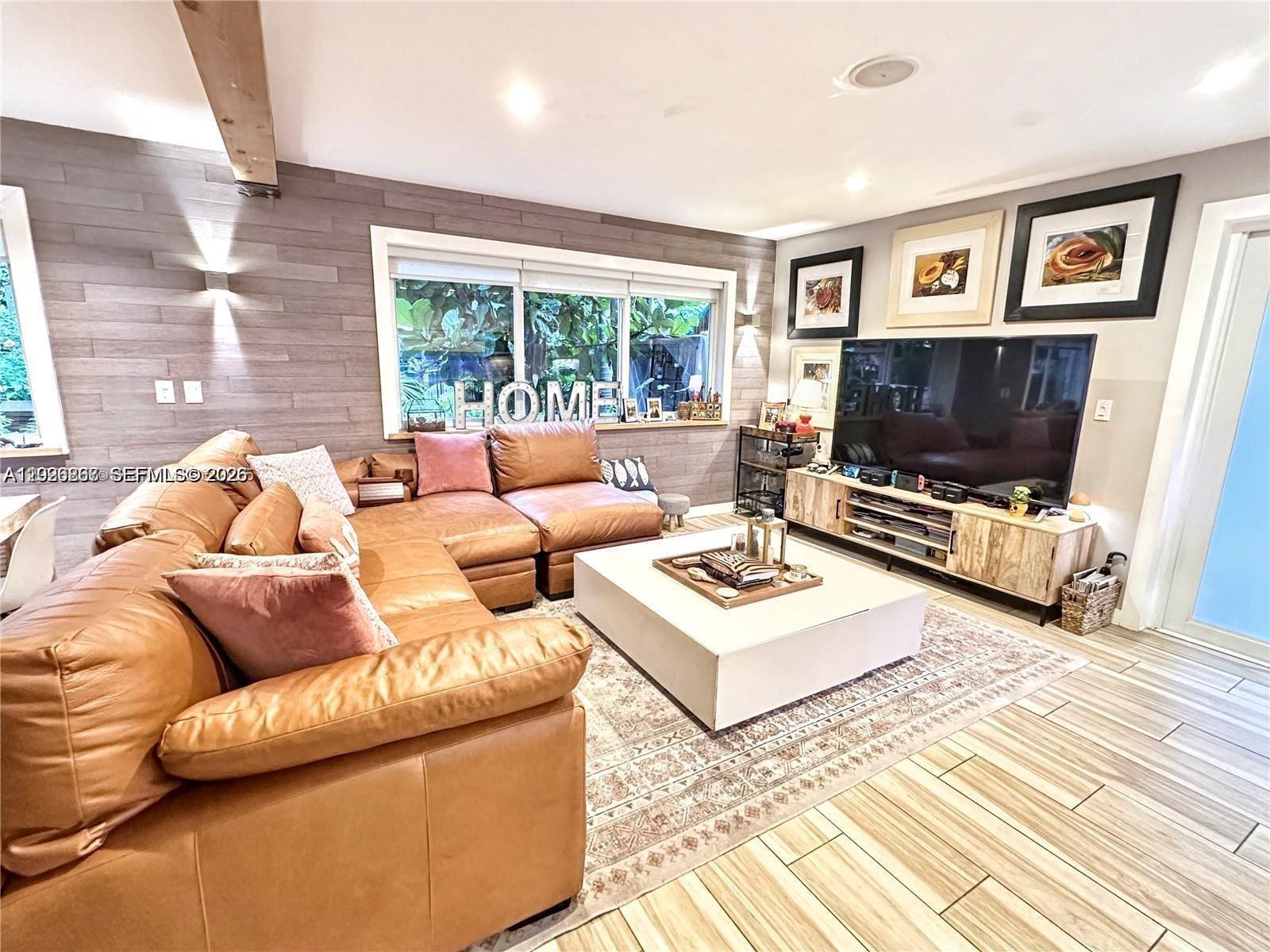 Rare South Beach find: A massive PRIVATE patio and fenced-in garden—a level of outdoor privacy virtually unavailable elsewhere in the area. This one-of-a-kind 1,200 sqft beachside retreat is anchored by large impact windows and stunning exposed wood ceilings, flooding the space with natural light while providing total storm protection. The high-design interior features 2 full bathrooms and an open-layout kitchen with a sleek island built for entertaining. The expansive walk-in closet includes a convenient in-unit washer/dryer. Step outside to your tropical, meticulously maintained garden with a barbecue setup and dedicated exterior storage specifically for this unit—perfect for bikes and beach gear. Total peace of mind is provided by a new 2023 roof and a secure, fully fenced perimeter. A rare opportunity for a high-design sanctuary with unmatched private outdoor living in the heart of SoBe.